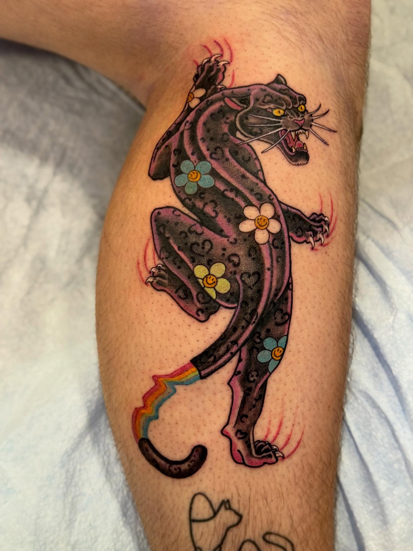 Panther with flowers American traditional tattoo on the thigh by English Cousins, Nashville, Tennessee