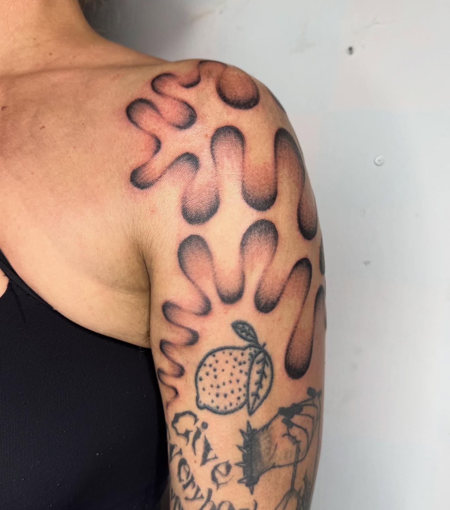 Abstract pattern with fruit dotwork tattoo on the shoulder by @mr.smiley___