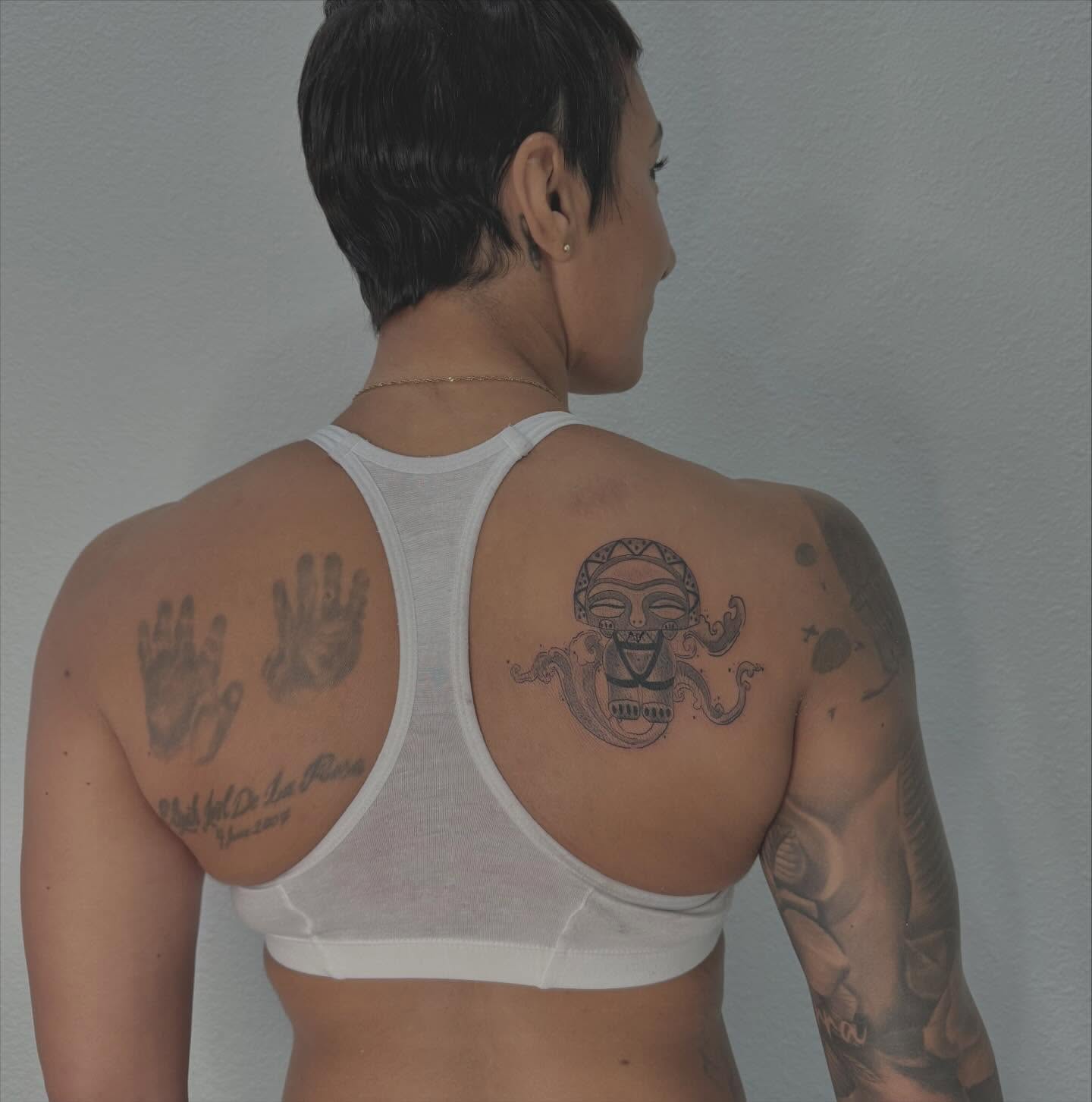 Hands and mask black and grey tattoo on the back by Las Vegas Tattoo Artist