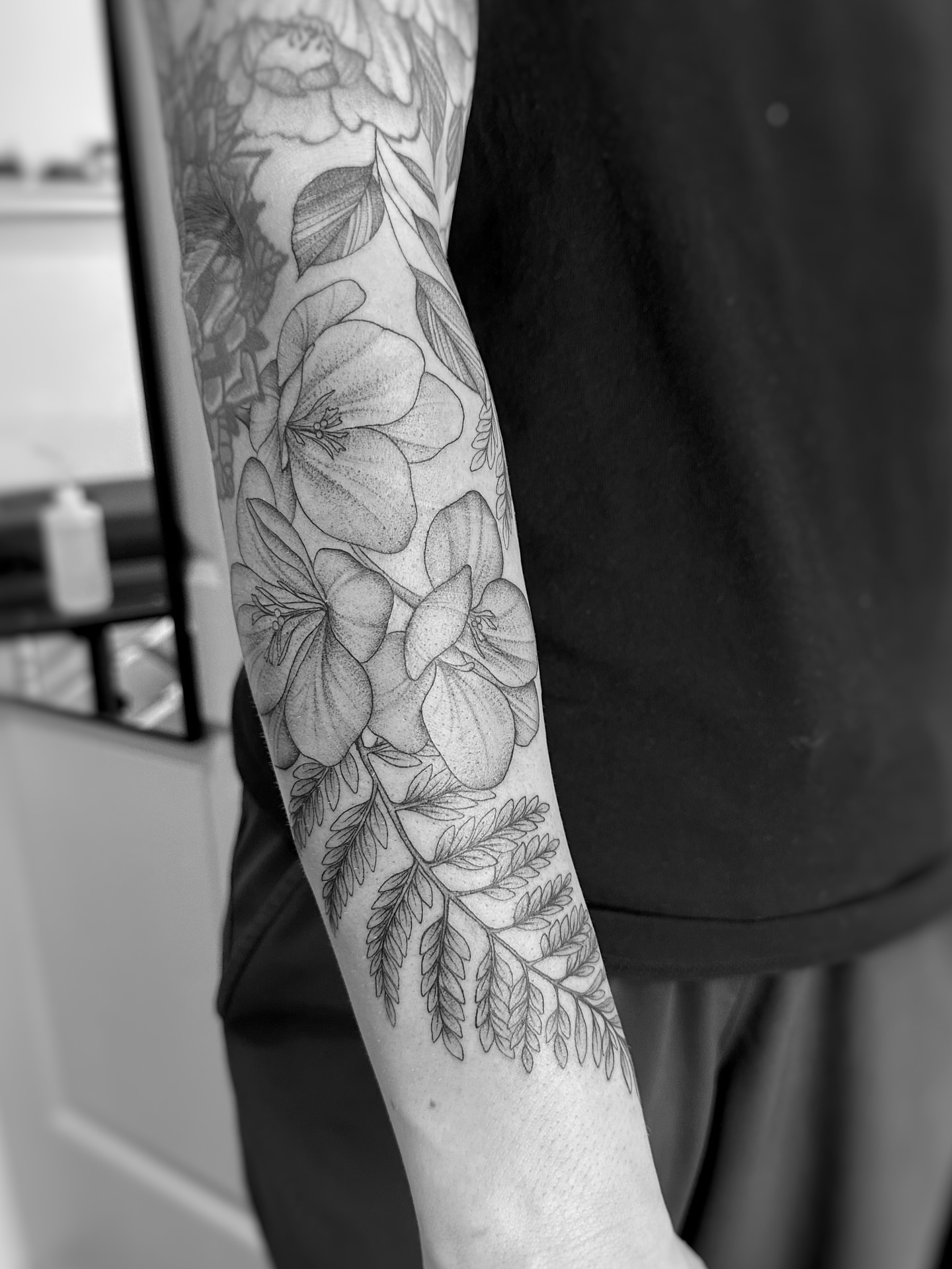 Floral arrangement black and grey tattoo on the forearm by jaclyn park