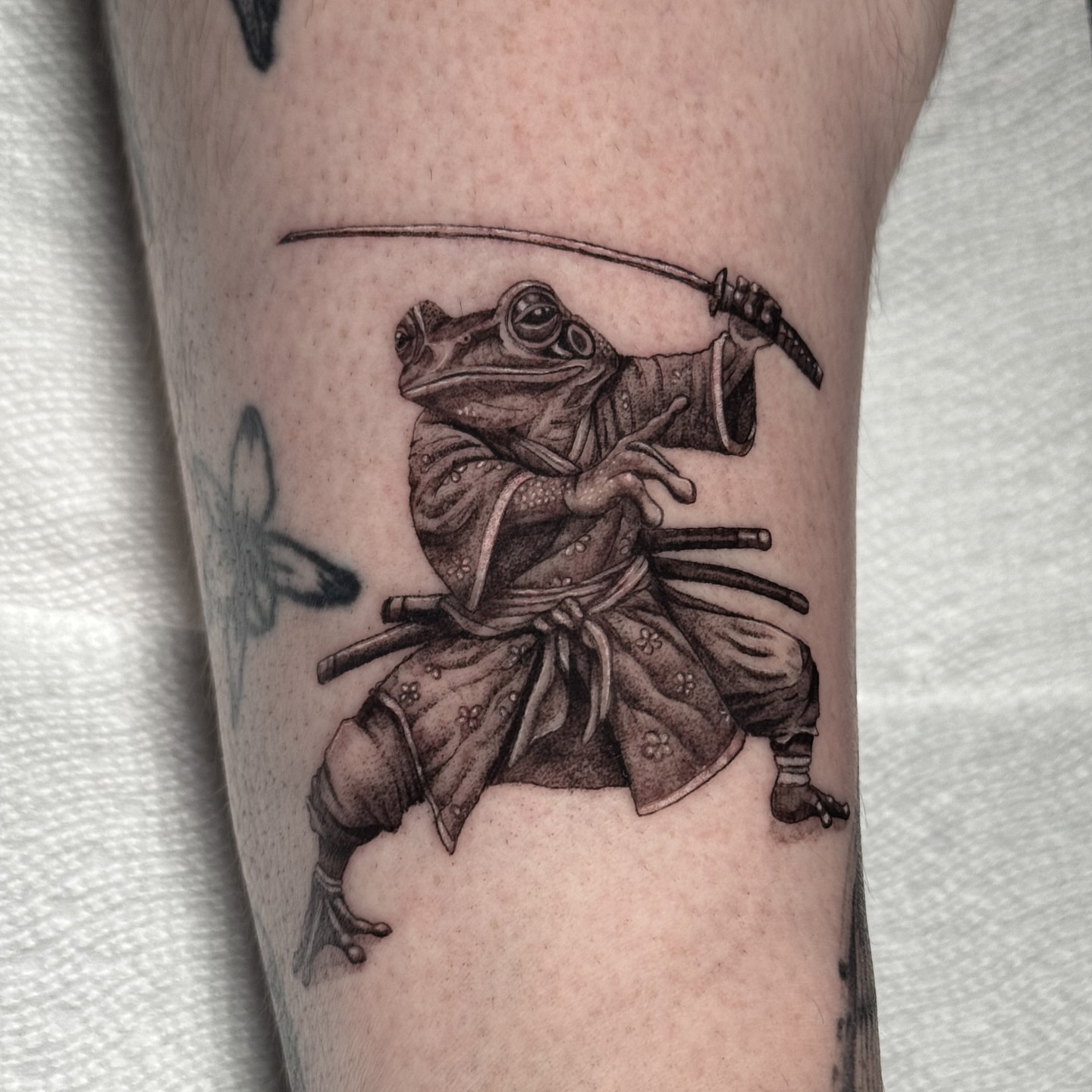 Frog samurai realism tattoo on the forearm by Brisia Cisneros