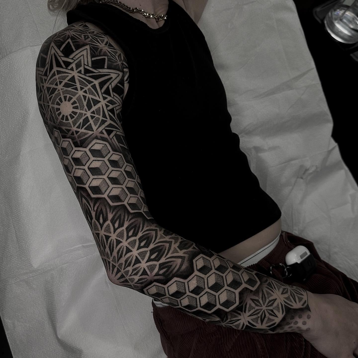 Geometric patterns geometric tattoo on the upper arm by Kevin Johnson