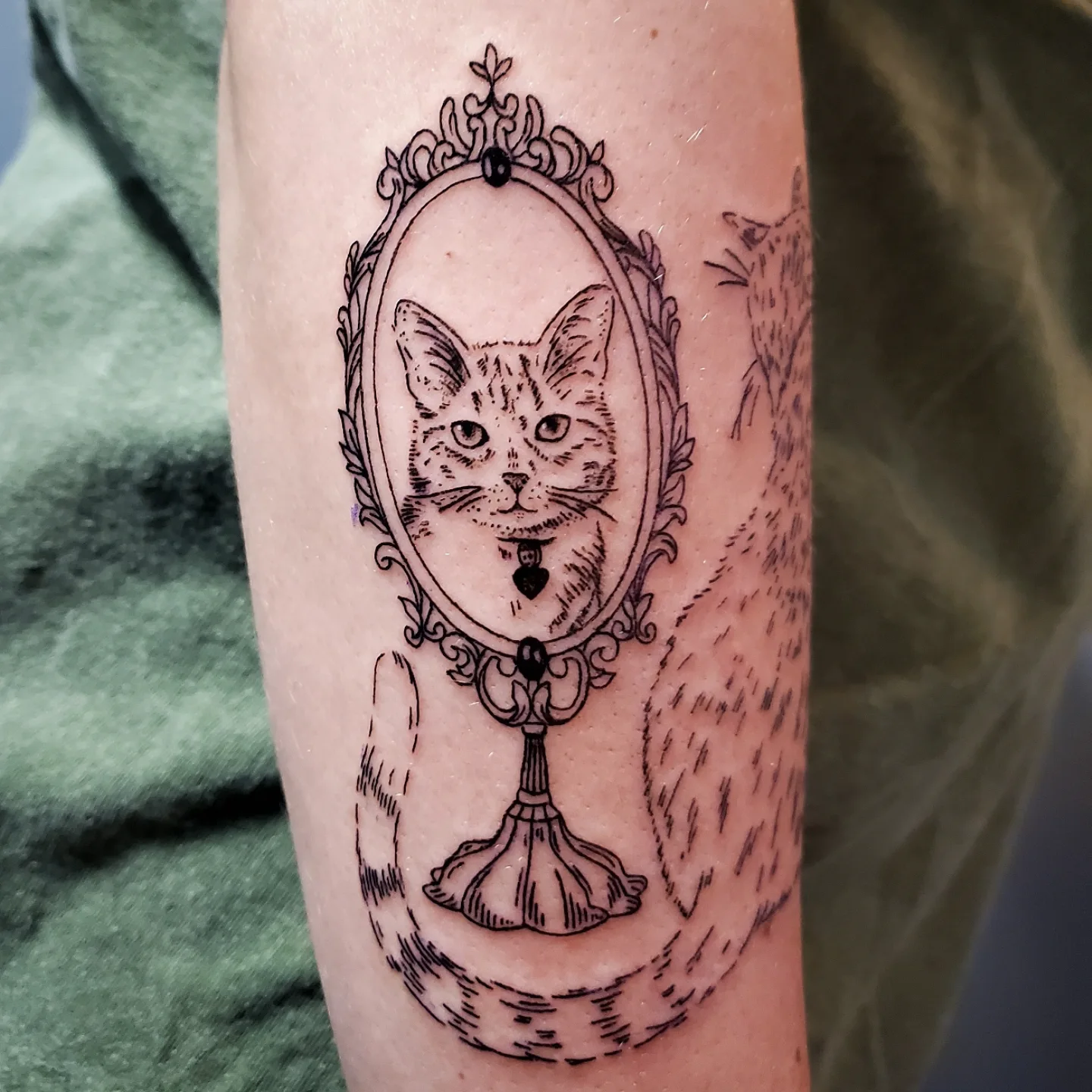 Cat in mirror realism tattoo on the forearm by Shailey Pasquale