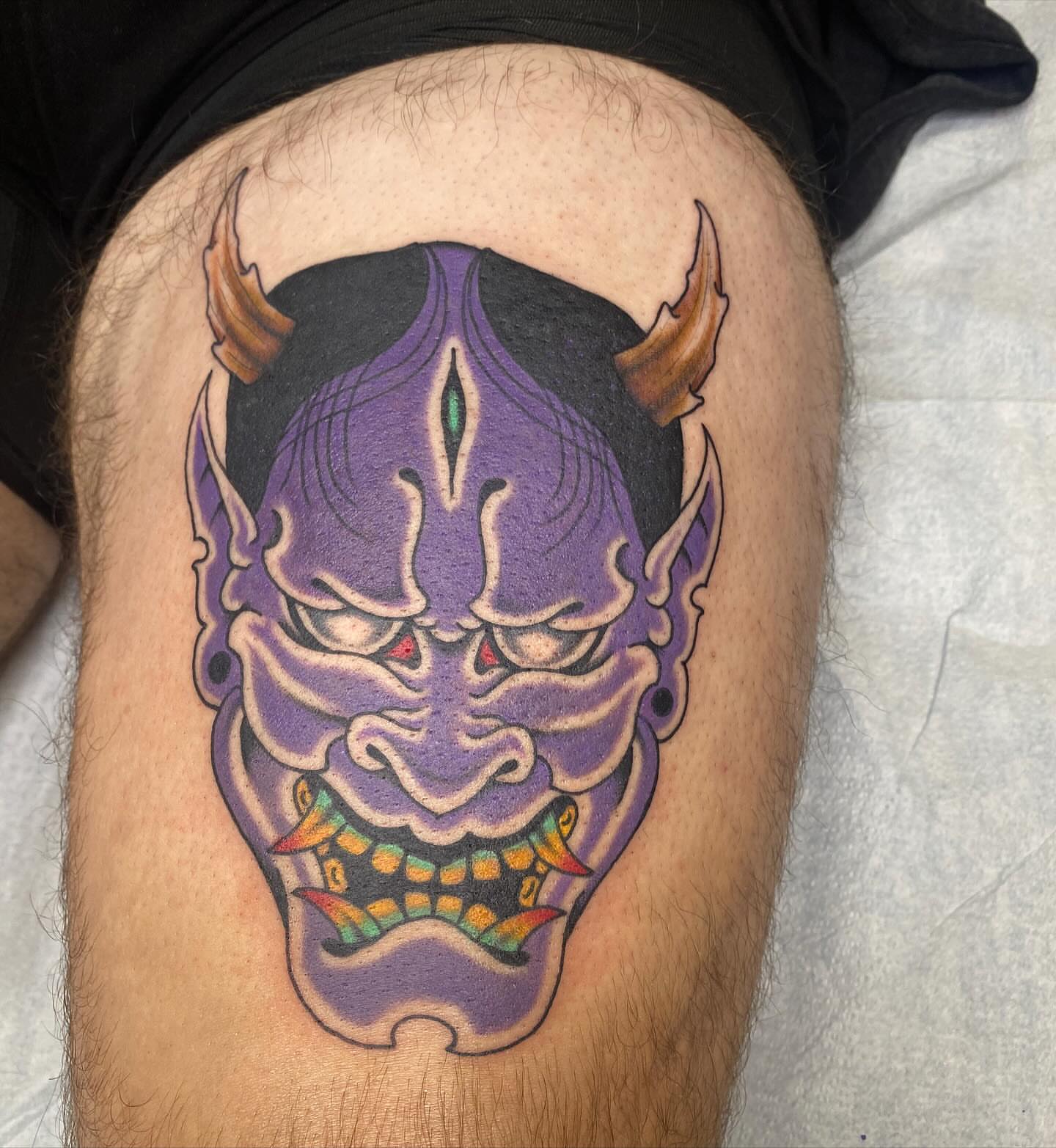 Demon mask japanese irezumi tattoo on the thigh by Thomas Cook