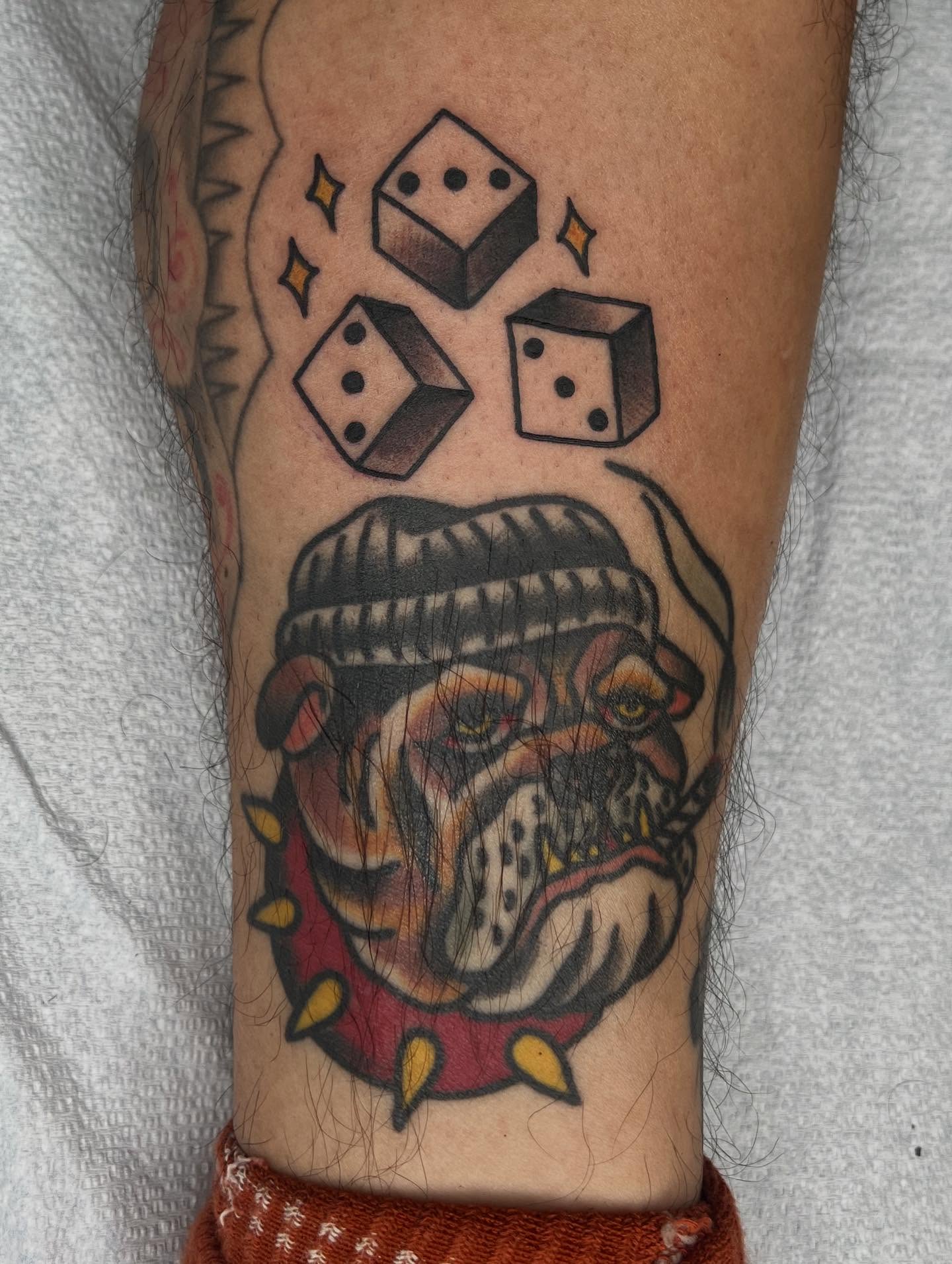 Bulldog with dice American traditional tattoo on the forearm by Mikey Montoya