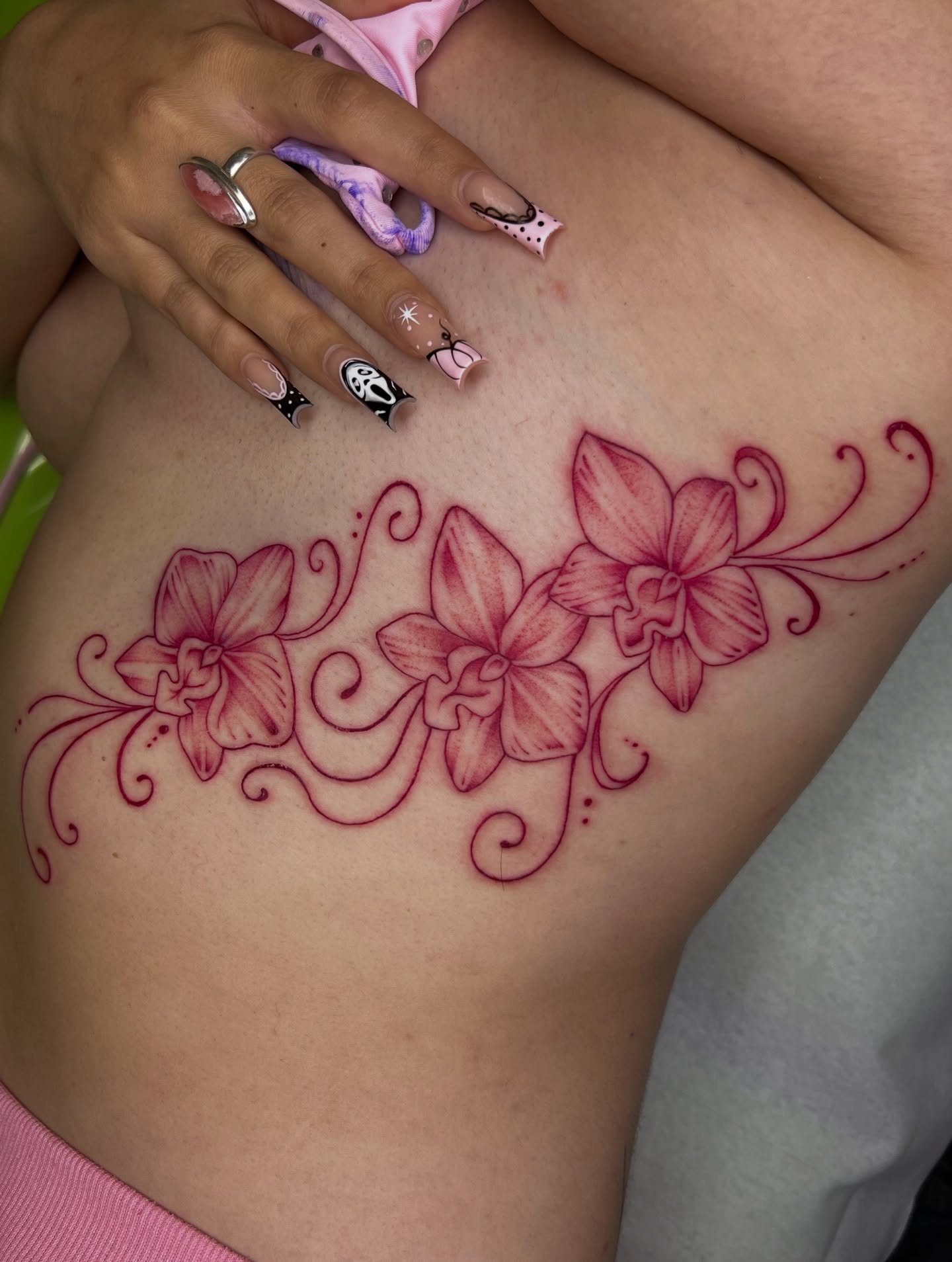 Orchids new school tattoo on the ribs by Nadia ★