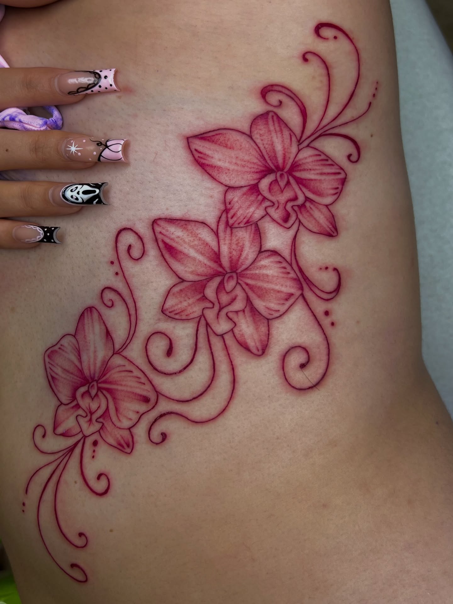 Orchids new school tattoo on the ribs by Nadia ★