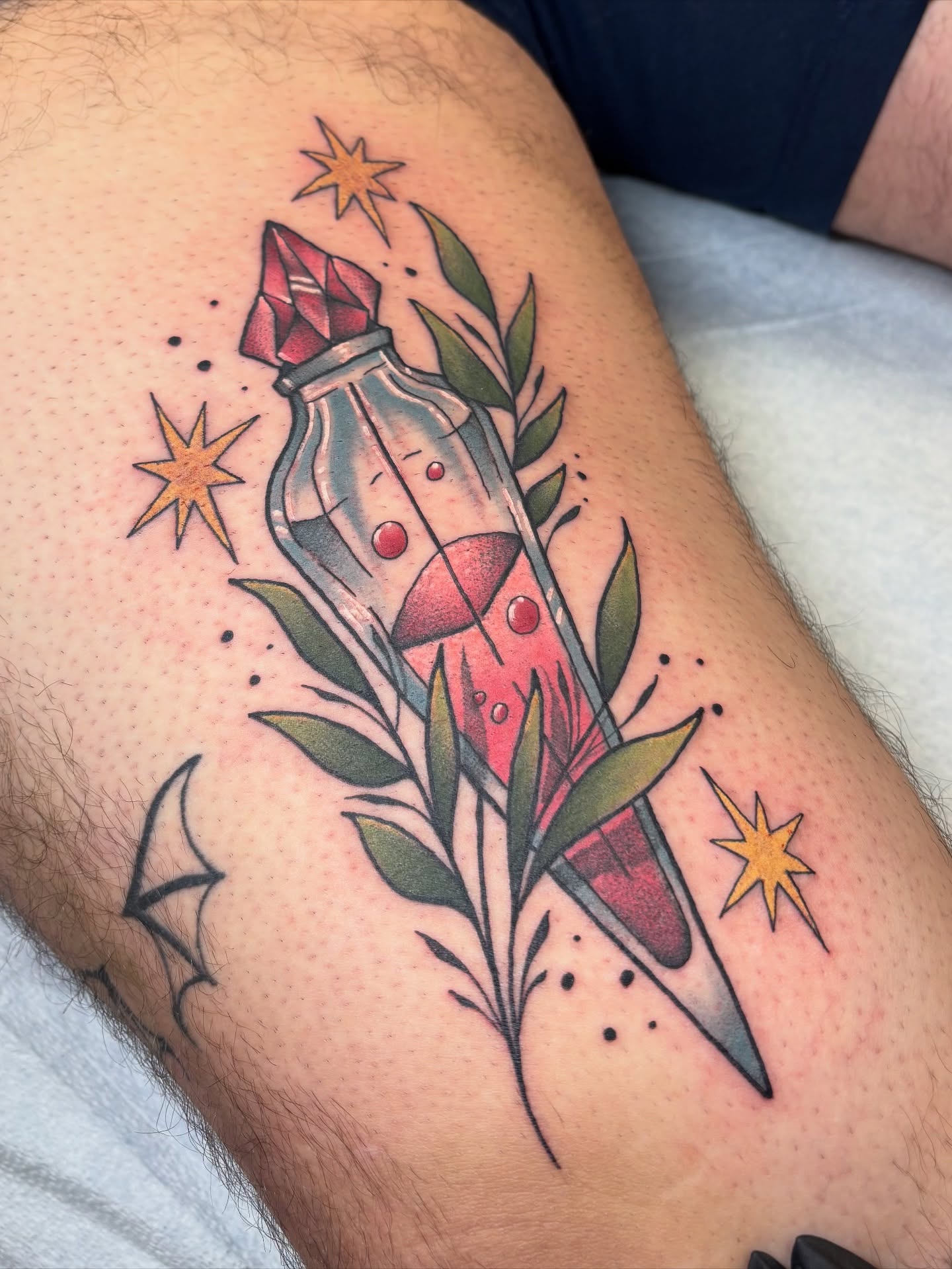 Vial with red liquid American traditional tattoo on the thigh by Dee - MA Tattoo Artist, Concord, Massachusetts