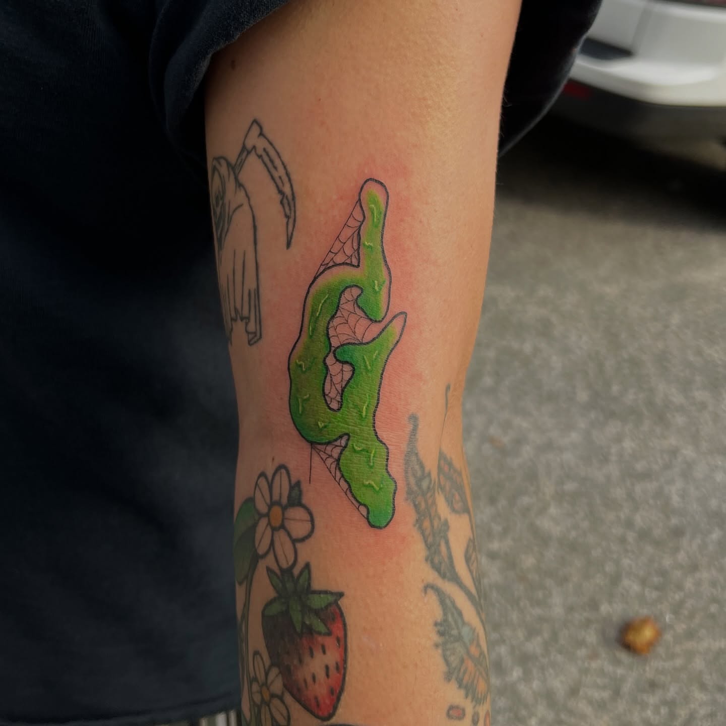 Green slime dotwork tattoo on the forearm by kobeigh