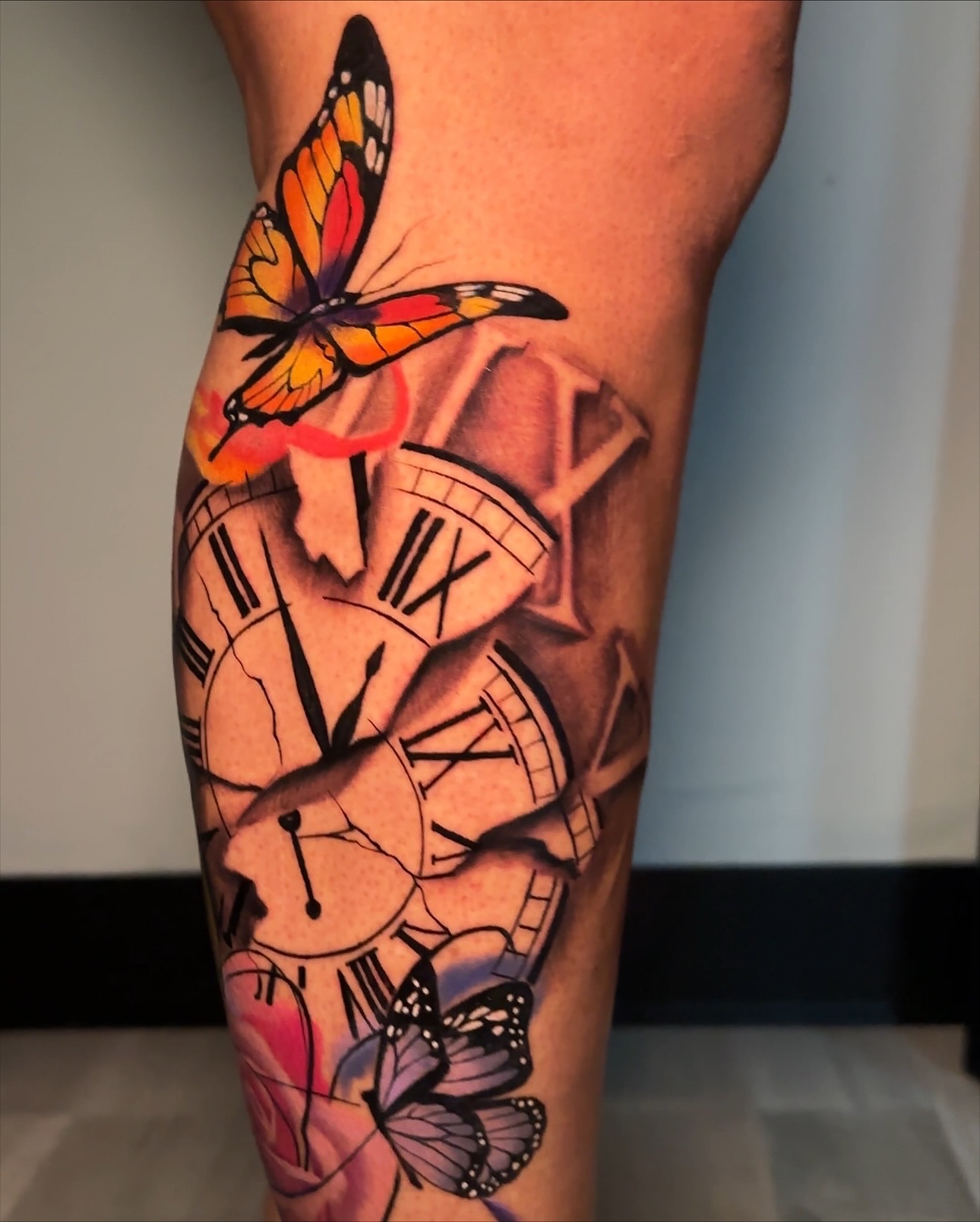 Clocks and butterflies realism tattoo on the forearm by Christopher Simmons