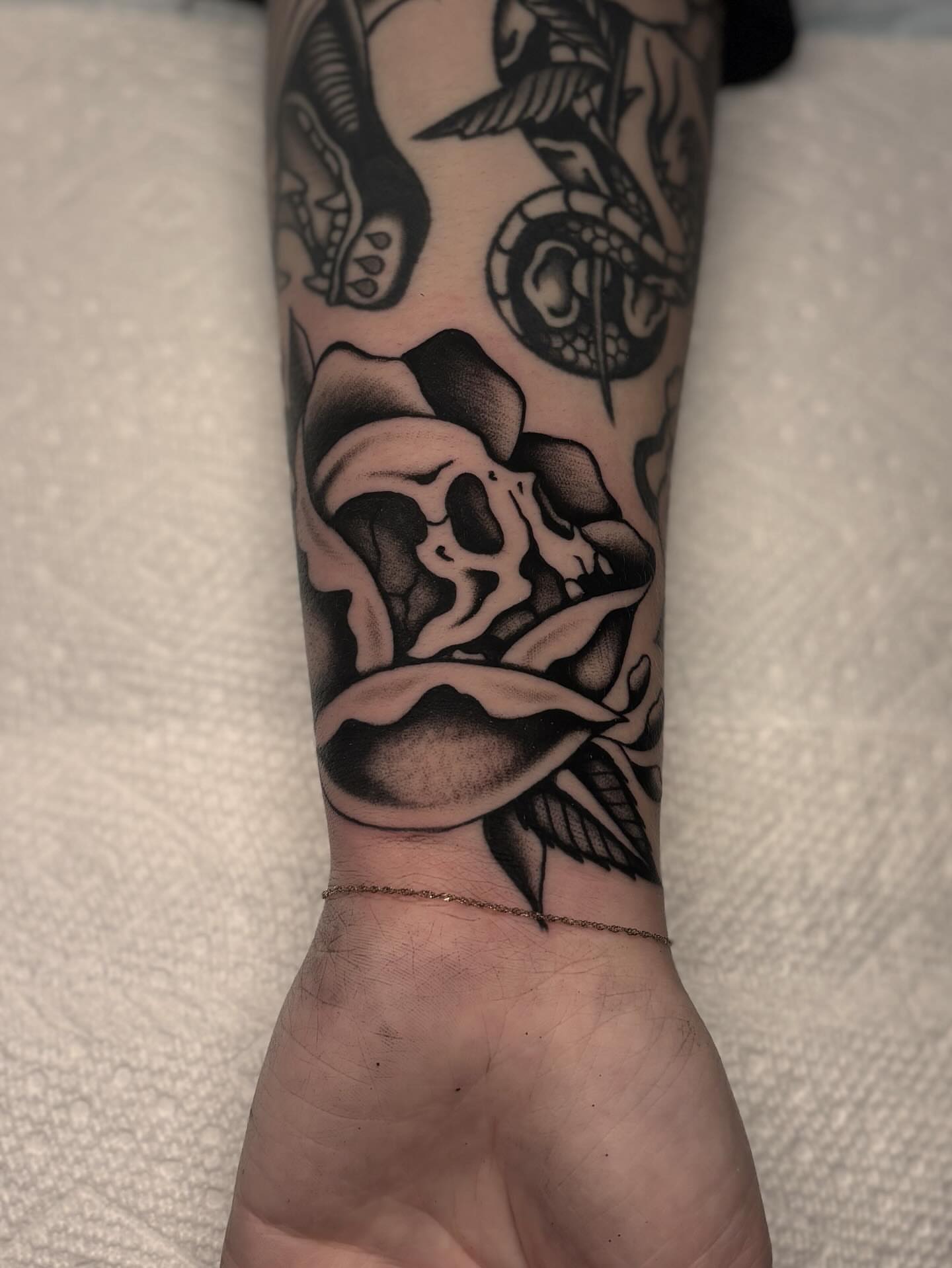 Skull and rose realism tattoo on the forearm by Jesse Smith, Chicago, Illinois