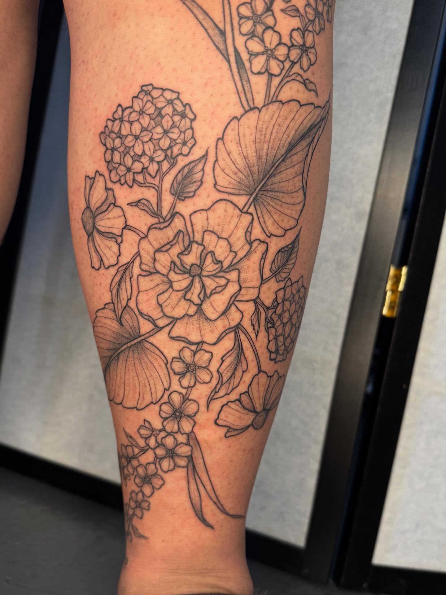 Floral arrangement black and grey tattoo on the forearm by Noelle Adrienne Tattoos