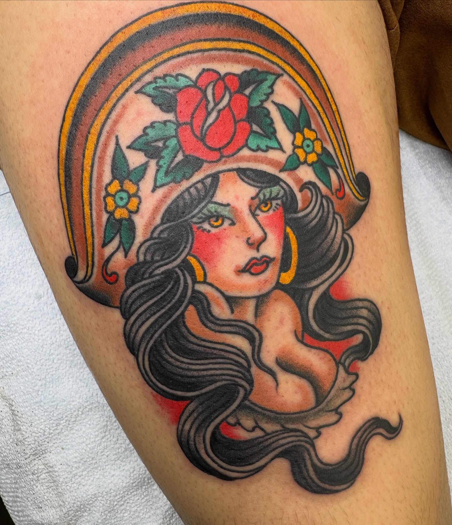Woman with roses American traditional tattoo on the thigh by Ben Karnofsky