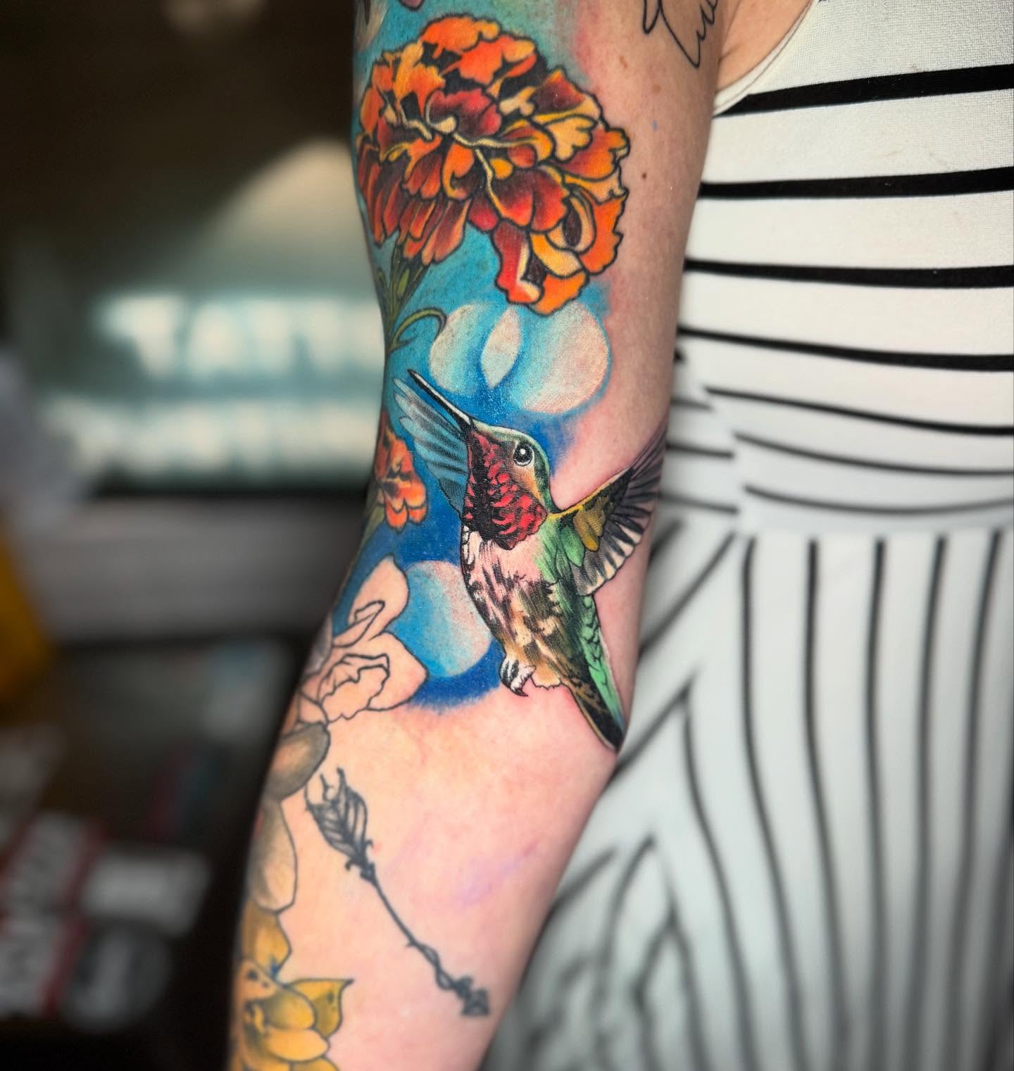 Hummingbird and flowers realism tattoo on the forearm by Bethany_pensacola fl body piercer