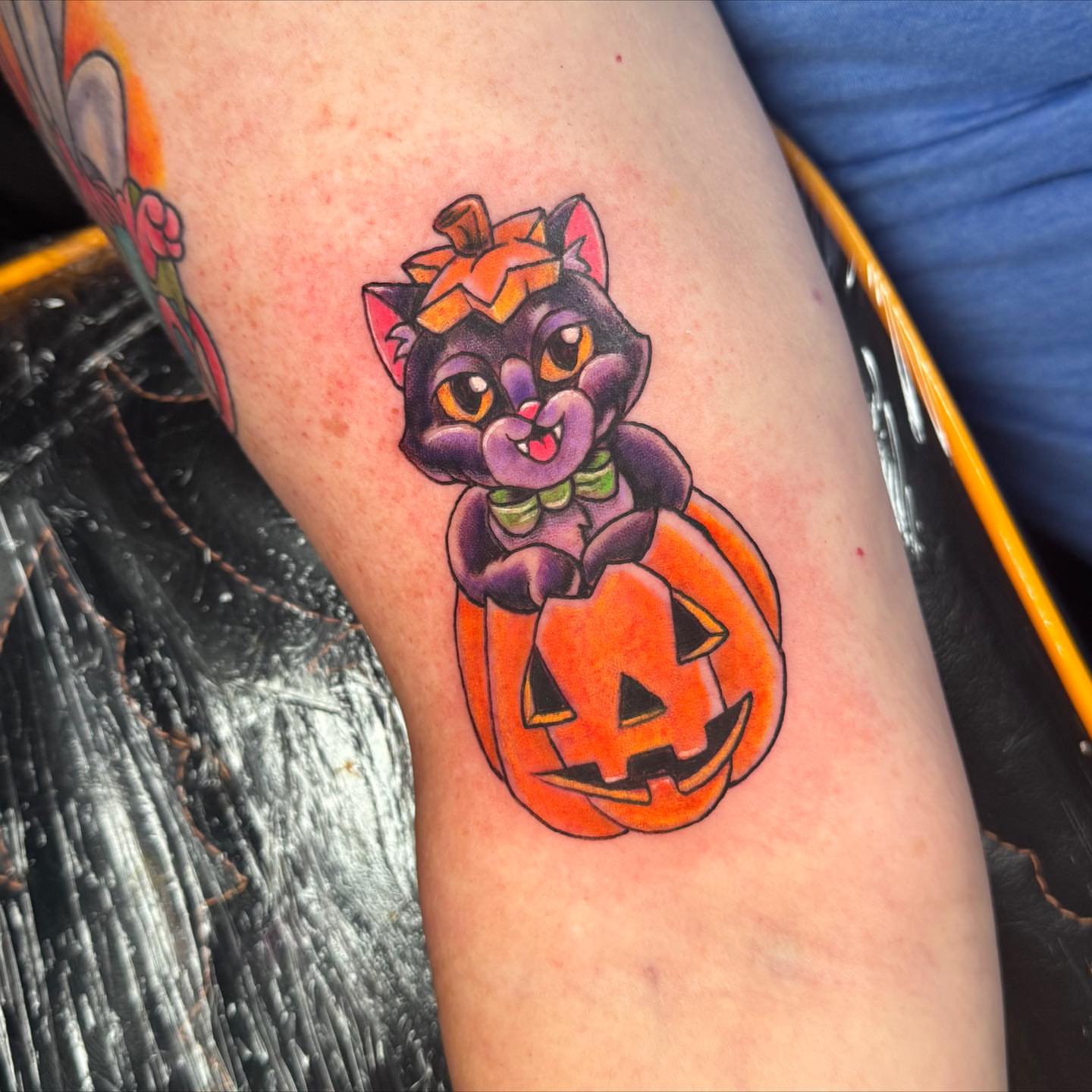 Cat in pumpkin American traditional tattoo on the forearm by Breanna B