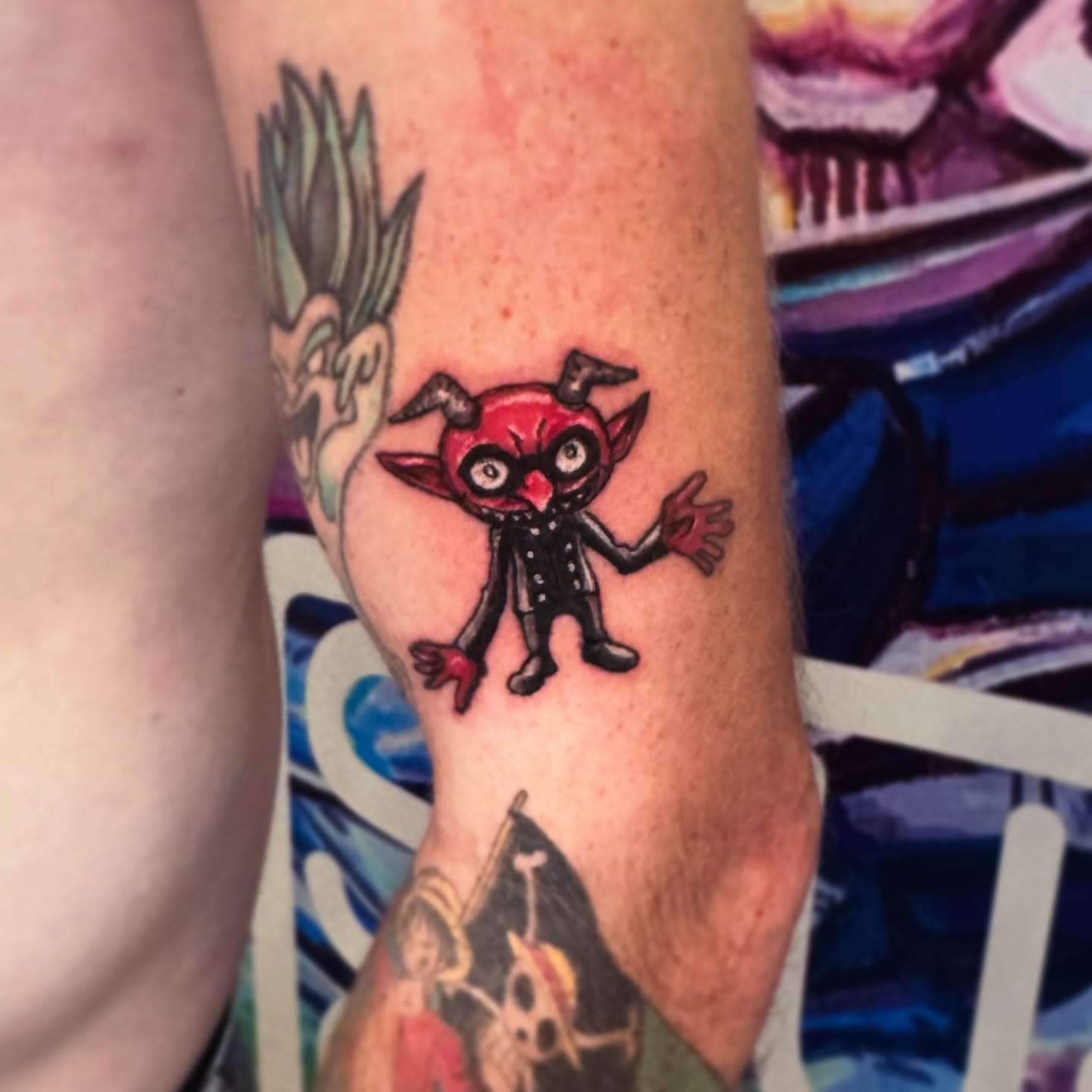 Red devil character anime tattoo on the forearm by Shushe ๐จ๐ด