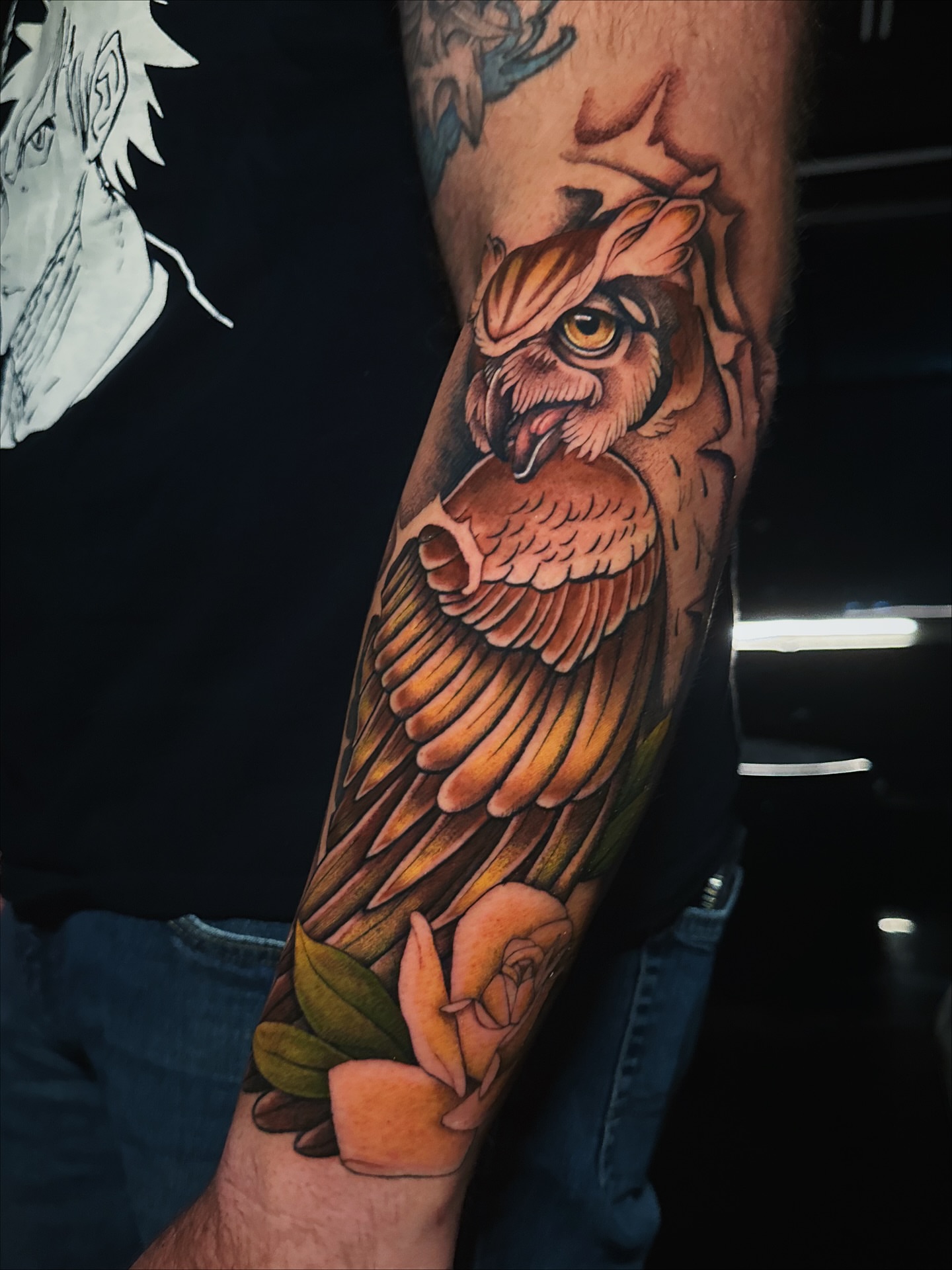 Owl and roses realism tattoo on the forearm by Kelsey Zussman