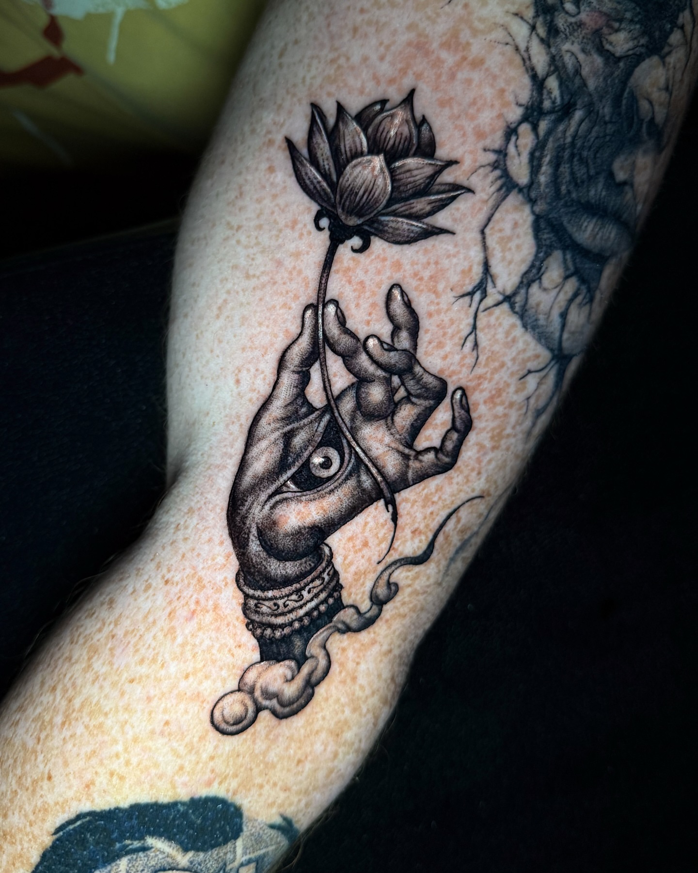 Hand with lotus black and grey tattoo on the forearm by Brandt Norcross