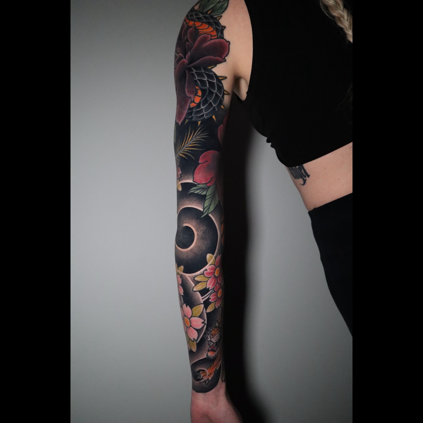 Floral and crescent moon American traditional tattoo on the forearm by Lauren Howard Tattoos