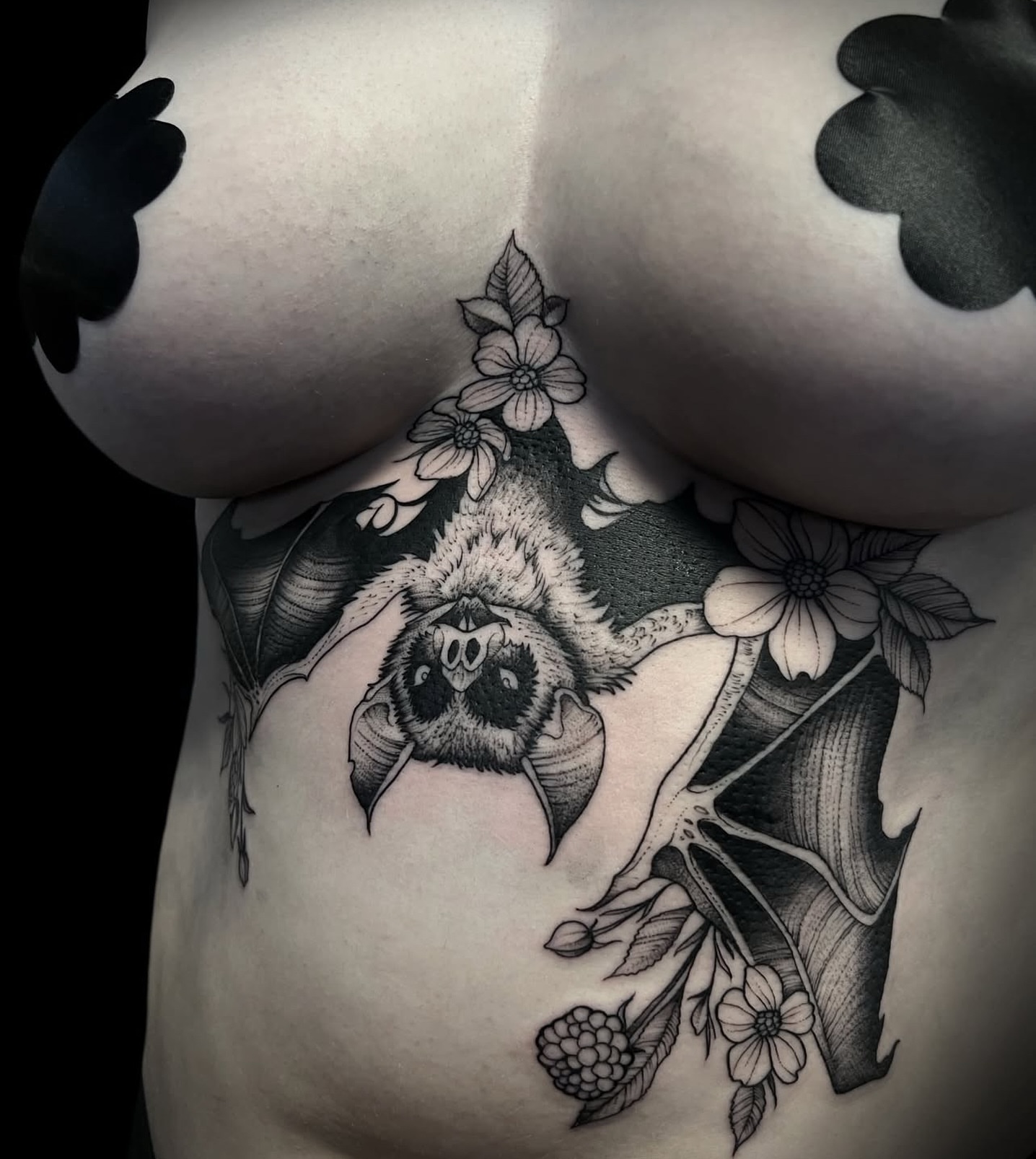 Bat and flowers realism tattoo on the ribs by Sterling Grice
