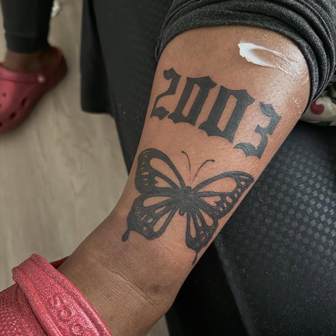 Year 2003 and butterfly fine line tattoo on the forearm by ๐ฆ