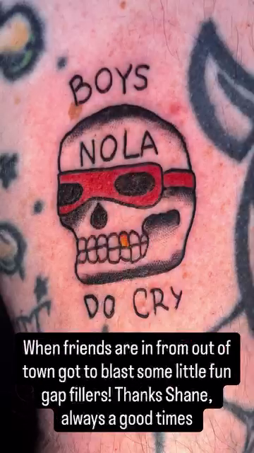 Skull with sunglasses and text American traditional tattoo on the upper arm by Davidsteeletattoos, Dallas, Texas