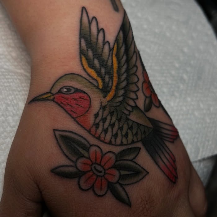 Hummingbird and flower American traditional tattoo on the hand by Kayla Faircloth, Charlotte, North Carolina