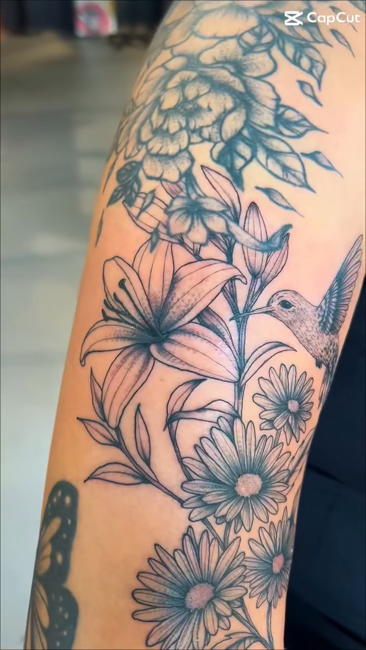 Flowers and a hummingbird fine line tattoo by @inkspirationtattoo_co