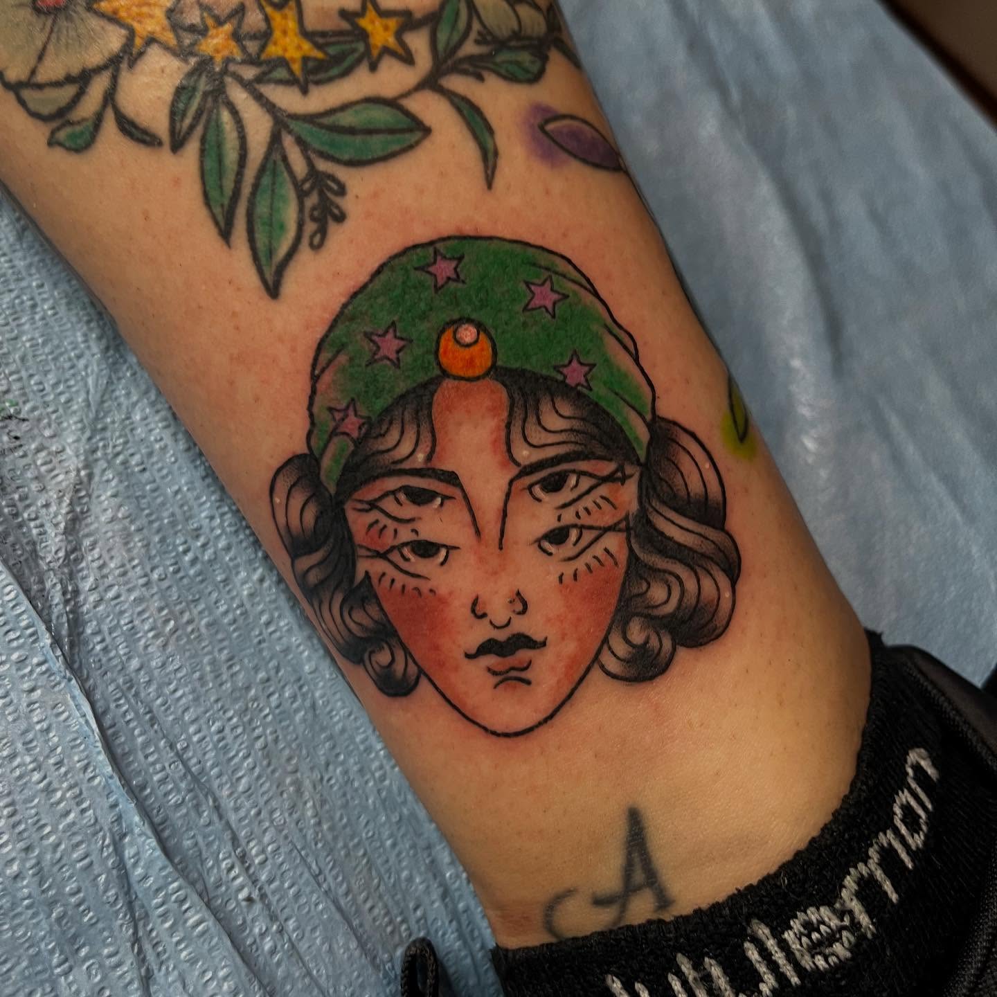 Woman's face American traditional tattoo on the forearm by Mariah Nguyen