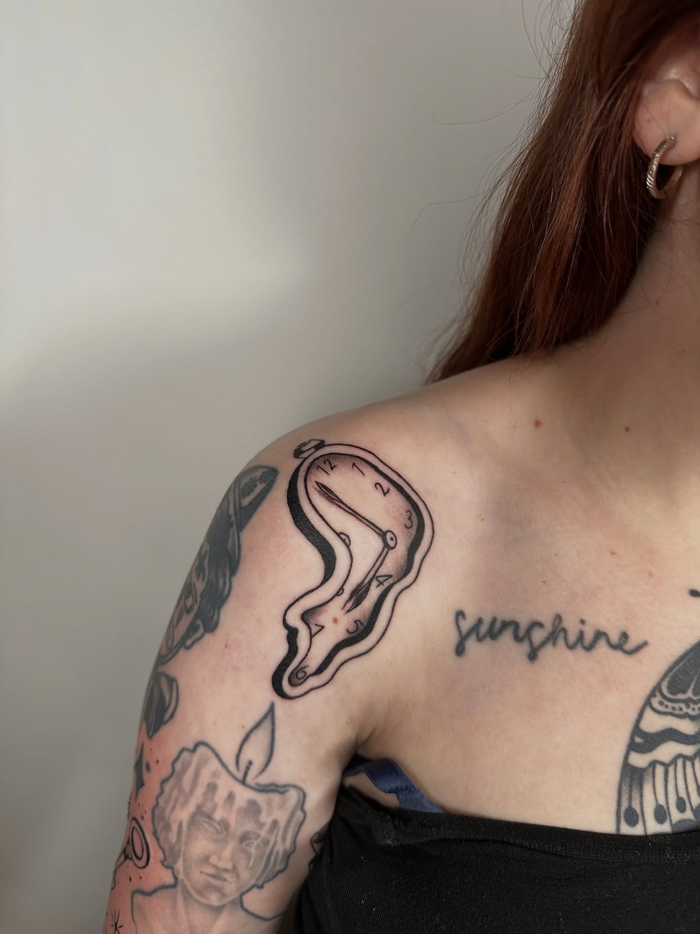 Clock black and grey tattoo on the shoulder by Heather Cherish