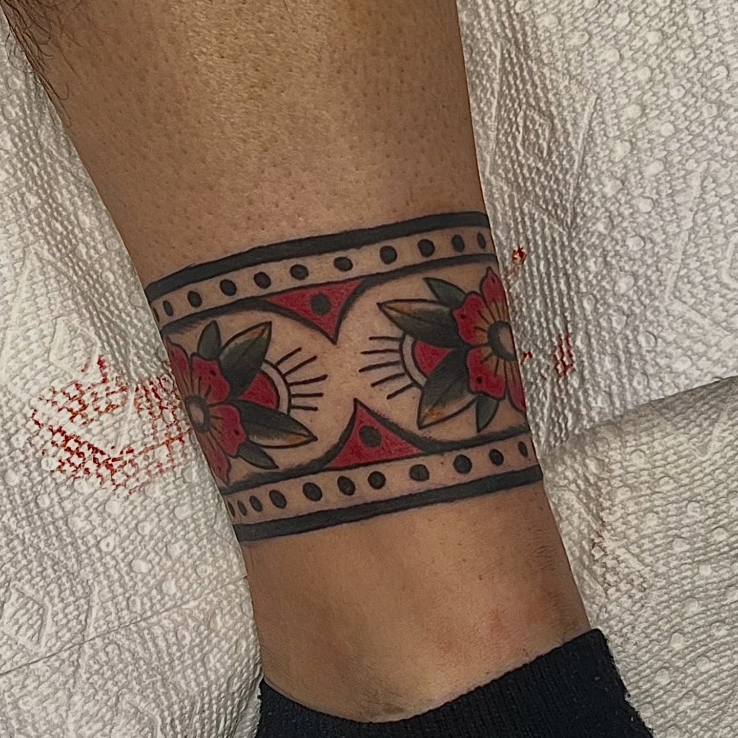 Floral band American traditional tattoo on the forearm by @brandonhuckabey, Denver, Colorado