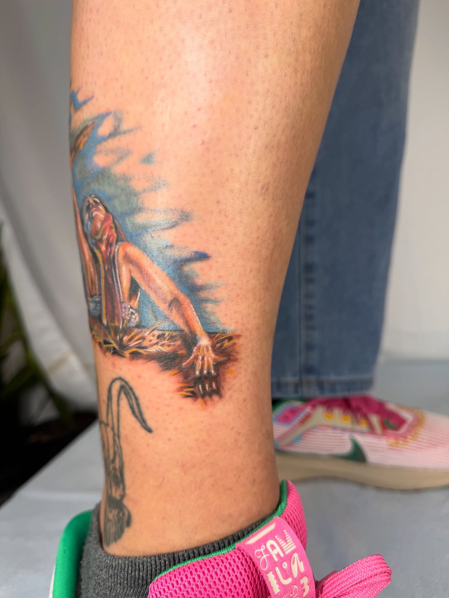 Woman lying on ground realism tattoo on the calf by Franky A Bonifacio, Seattle, Washington