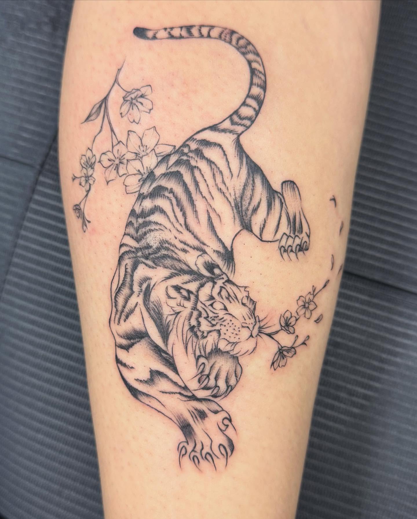 Tiger and cherry blossoms realism tattoo on the thigh by RyAnn Lynn