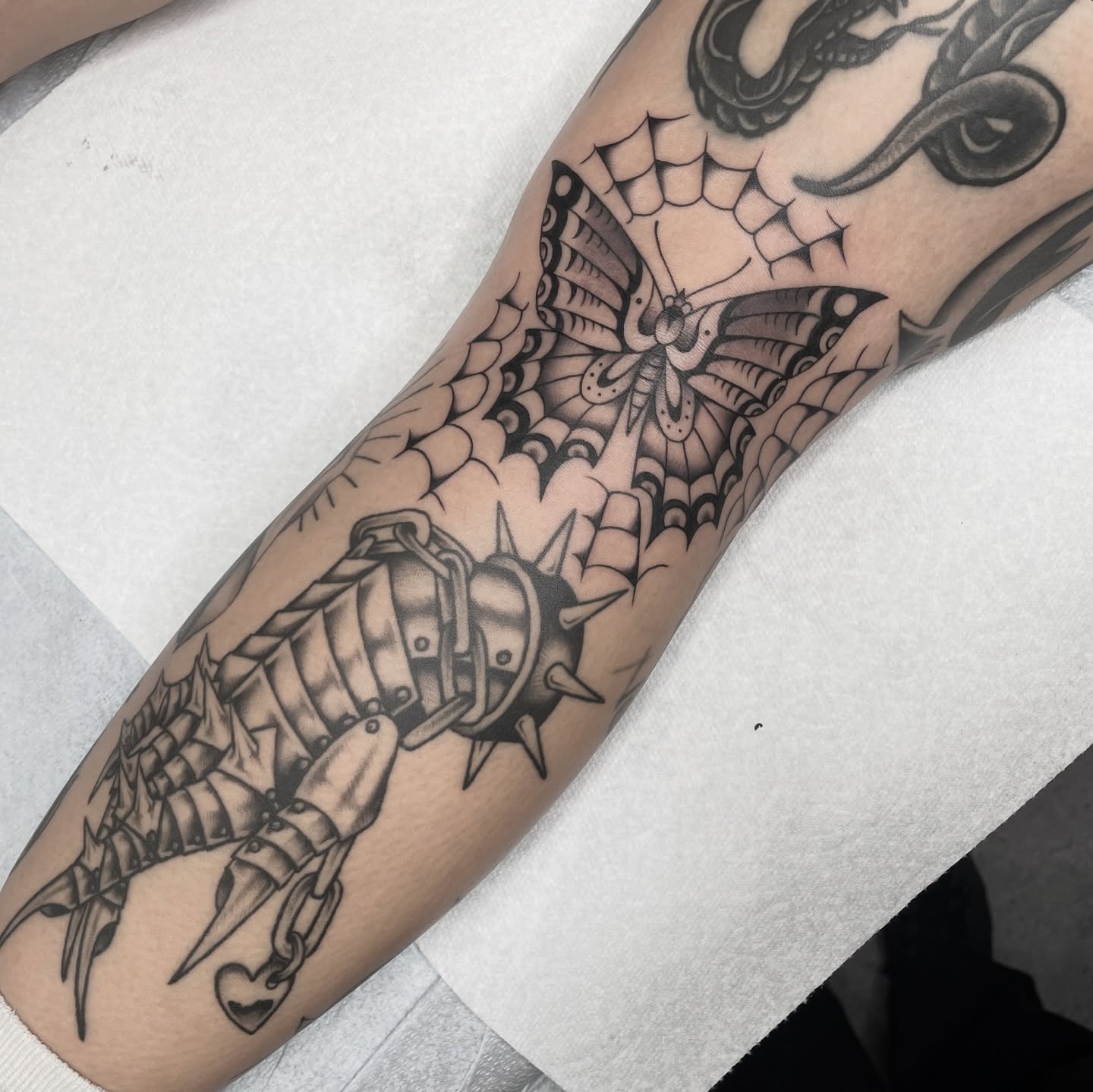 Scorpion and butterfly geometric tattoo on the forearm by Dakota Jenner