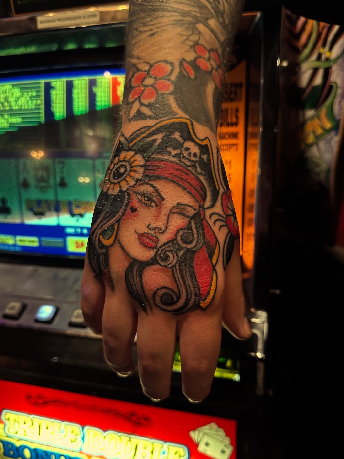 Woman with flowers American traditional tattoo on the hand by Nick Weaver