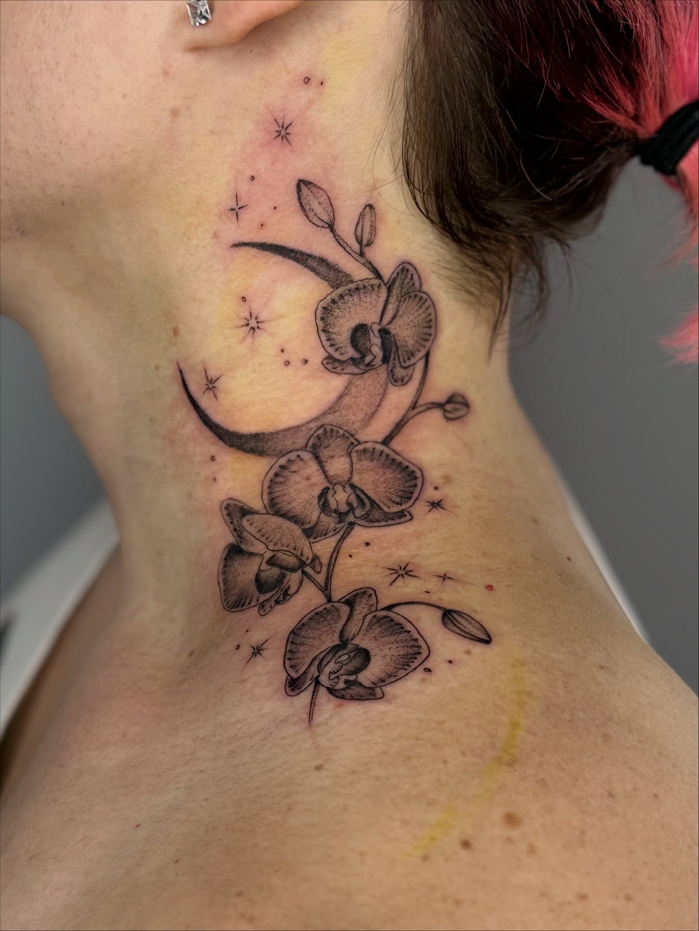Orchids and crescent moon dotwork tattoo on the neck by Brandie