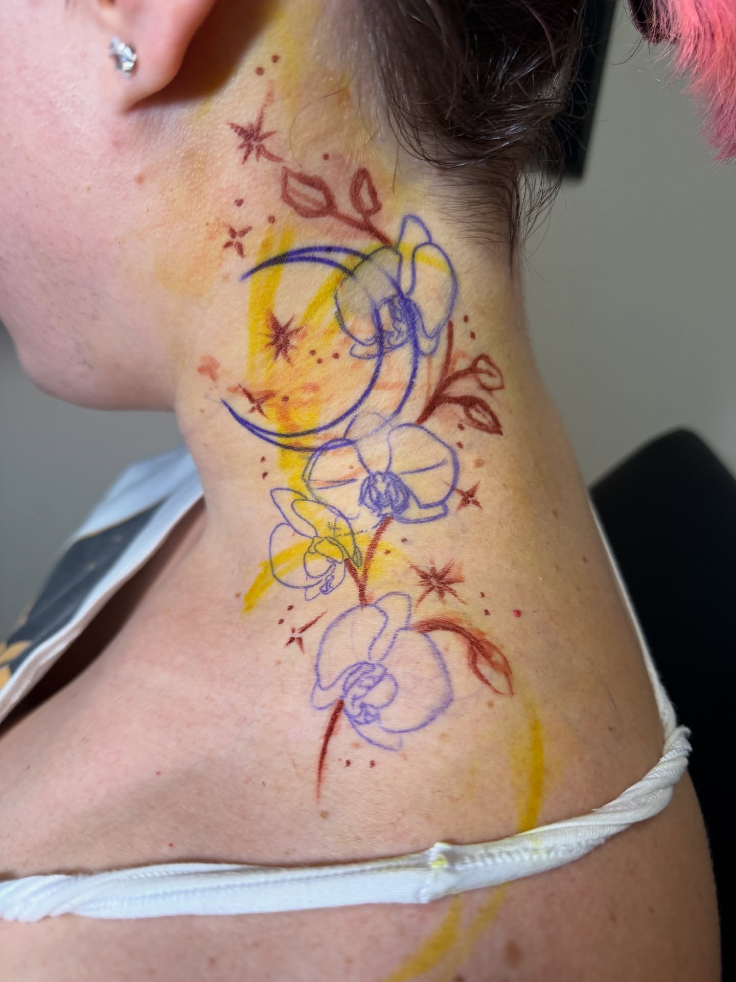Flowers and crescent moon watercolor tattoo on the neck by Brandie