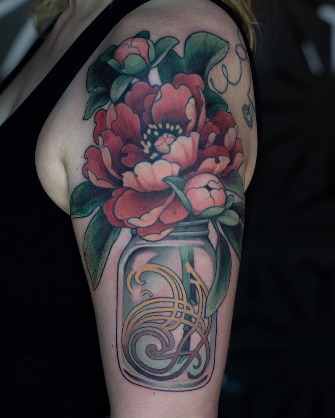 Peony bouquet in jar American traditional tattoo on the upper arm by Hannah Steele