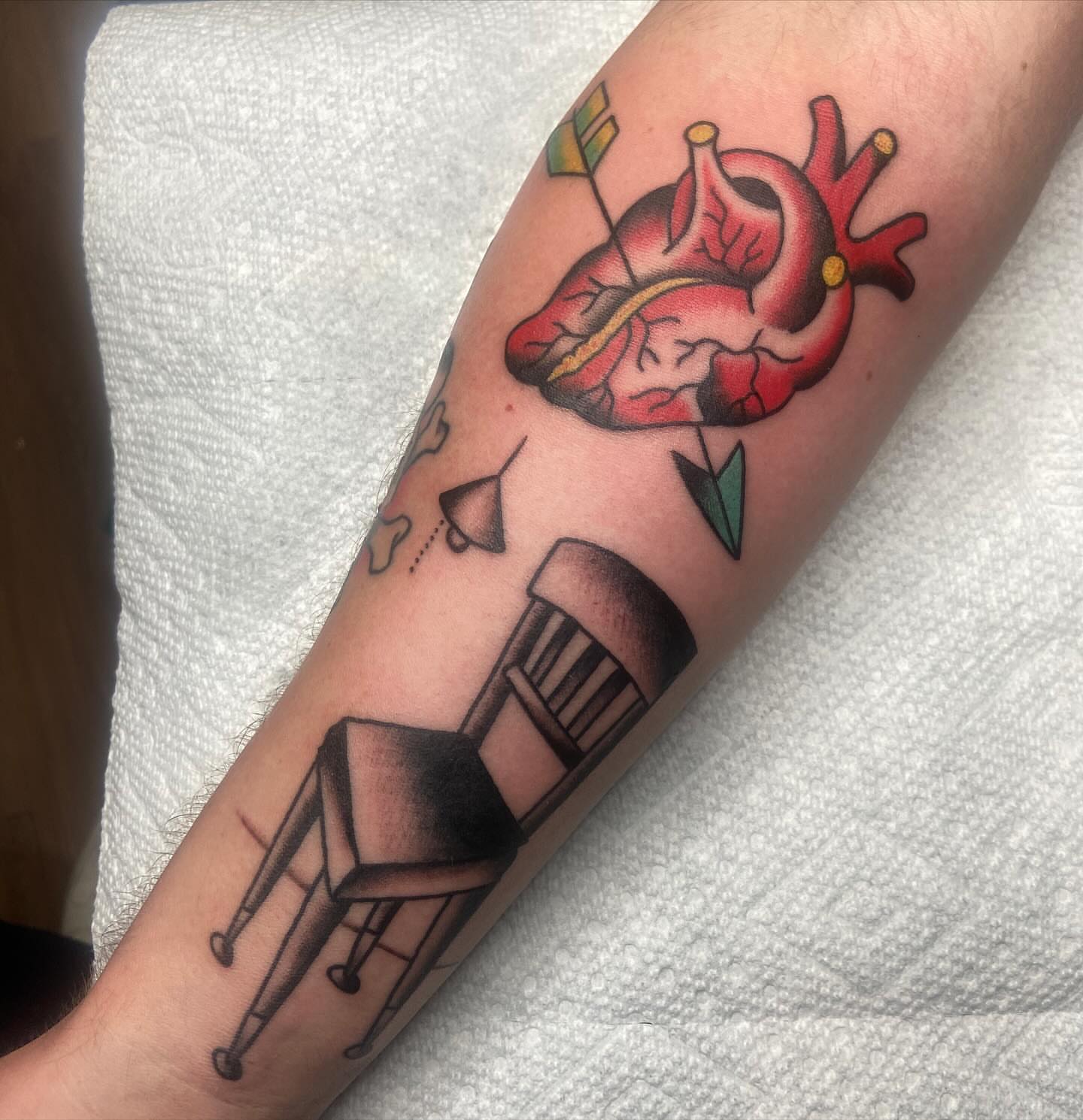 Heart with chair American traditional tattoo on the forearm by nicholas mcevoy, Boston, Massachusetts