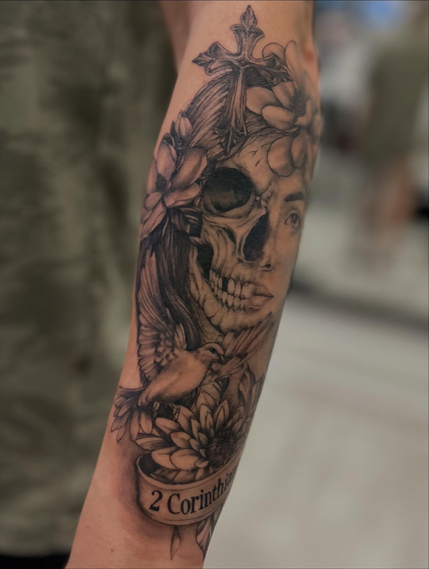 Skull with flowers and bird realism tattoo on the forearm by Jbtattoo Artistry