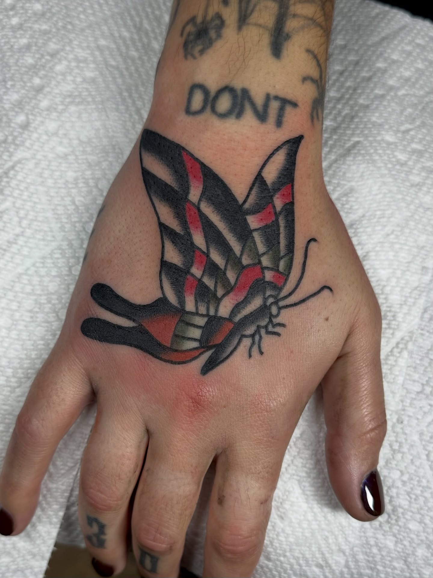 Butterfly American traditional tattoo on the hand by Steven