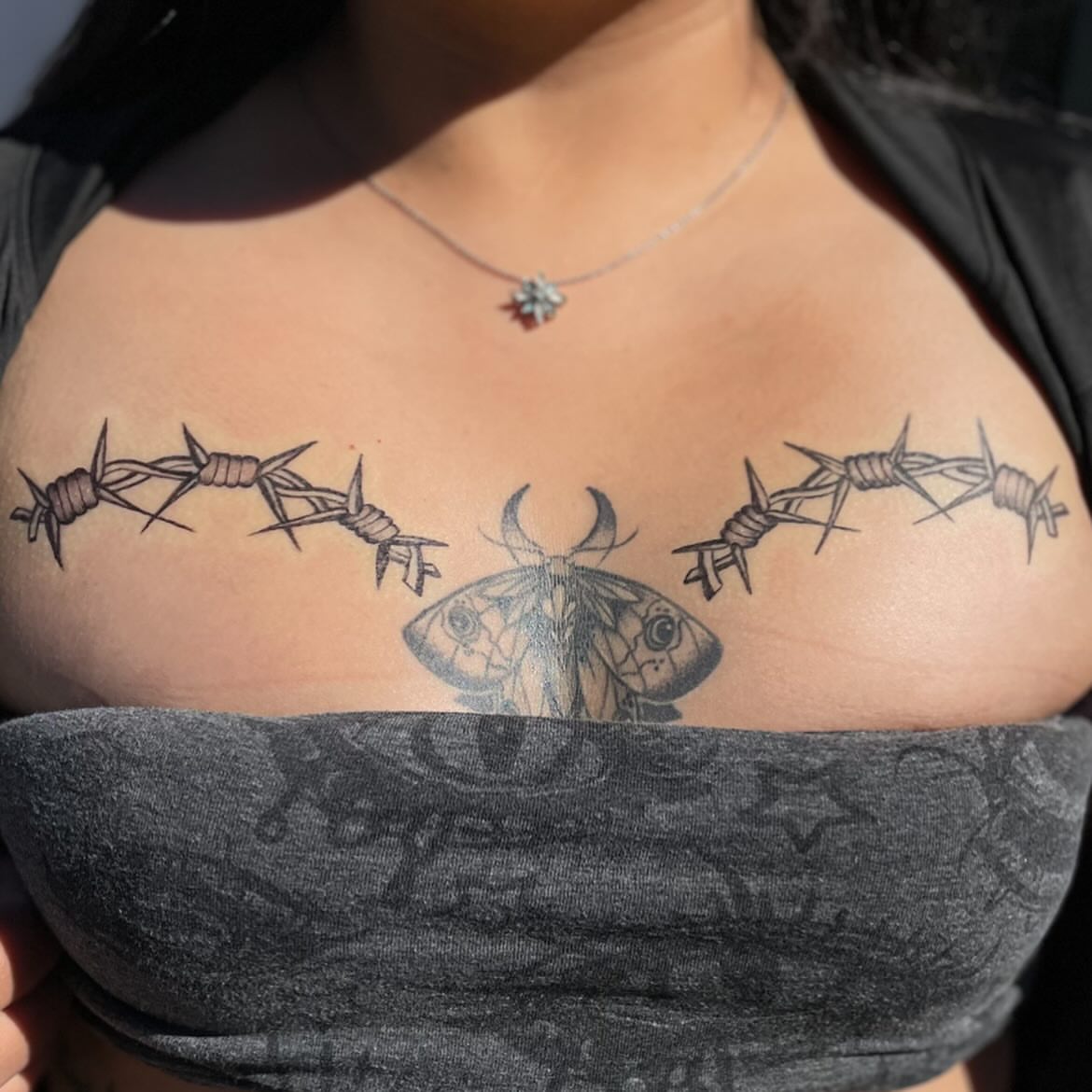 Barbed wire moth realism tattoo on the chest by Trinity