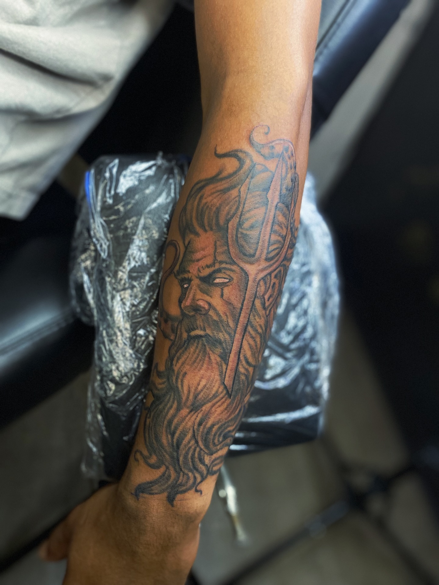 God-like figure realism tattoo on the forearm by Rico Rosario