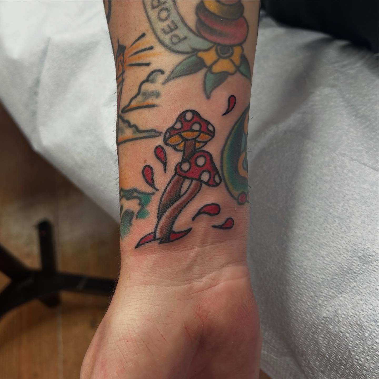 Mushrooms American traditional tattoo on the forearm by Elizabeth Niederkorn