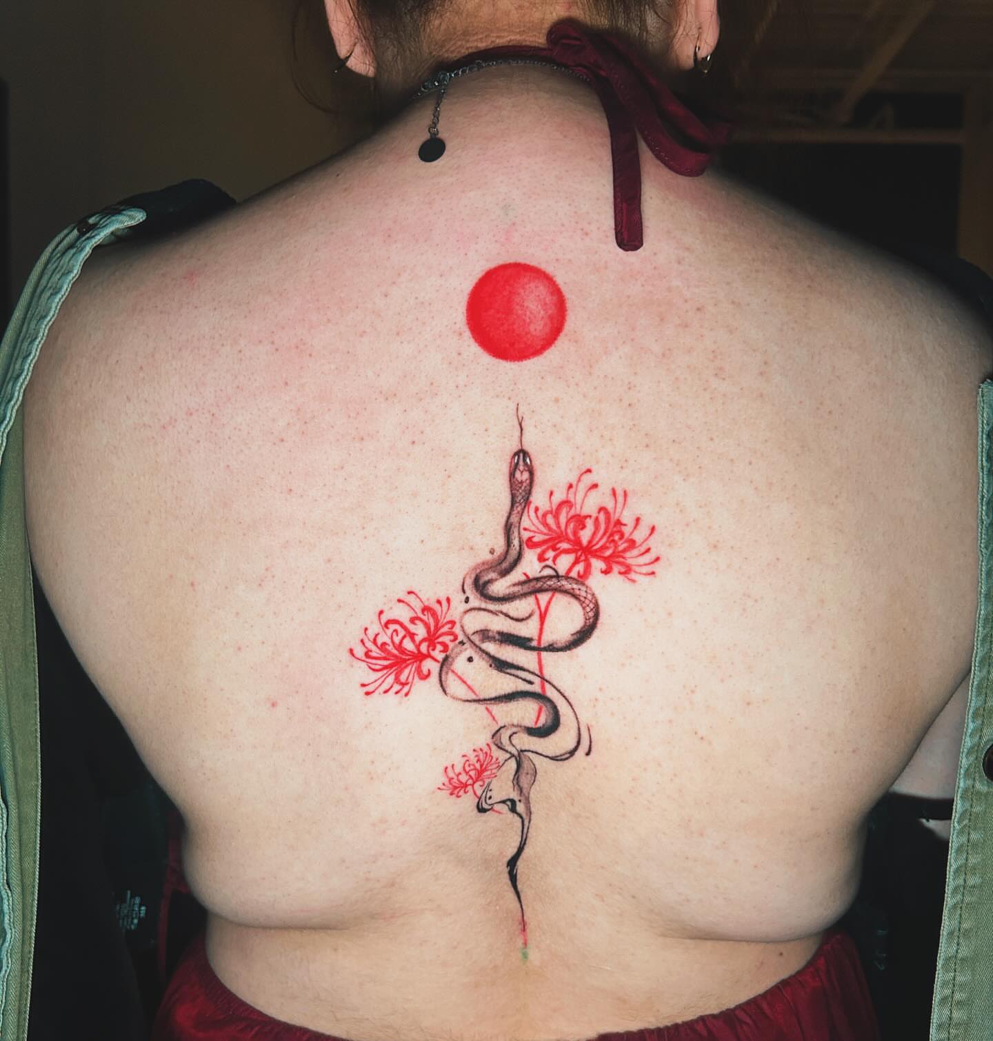 Snake and flowers dotwork tattoo on the back by J