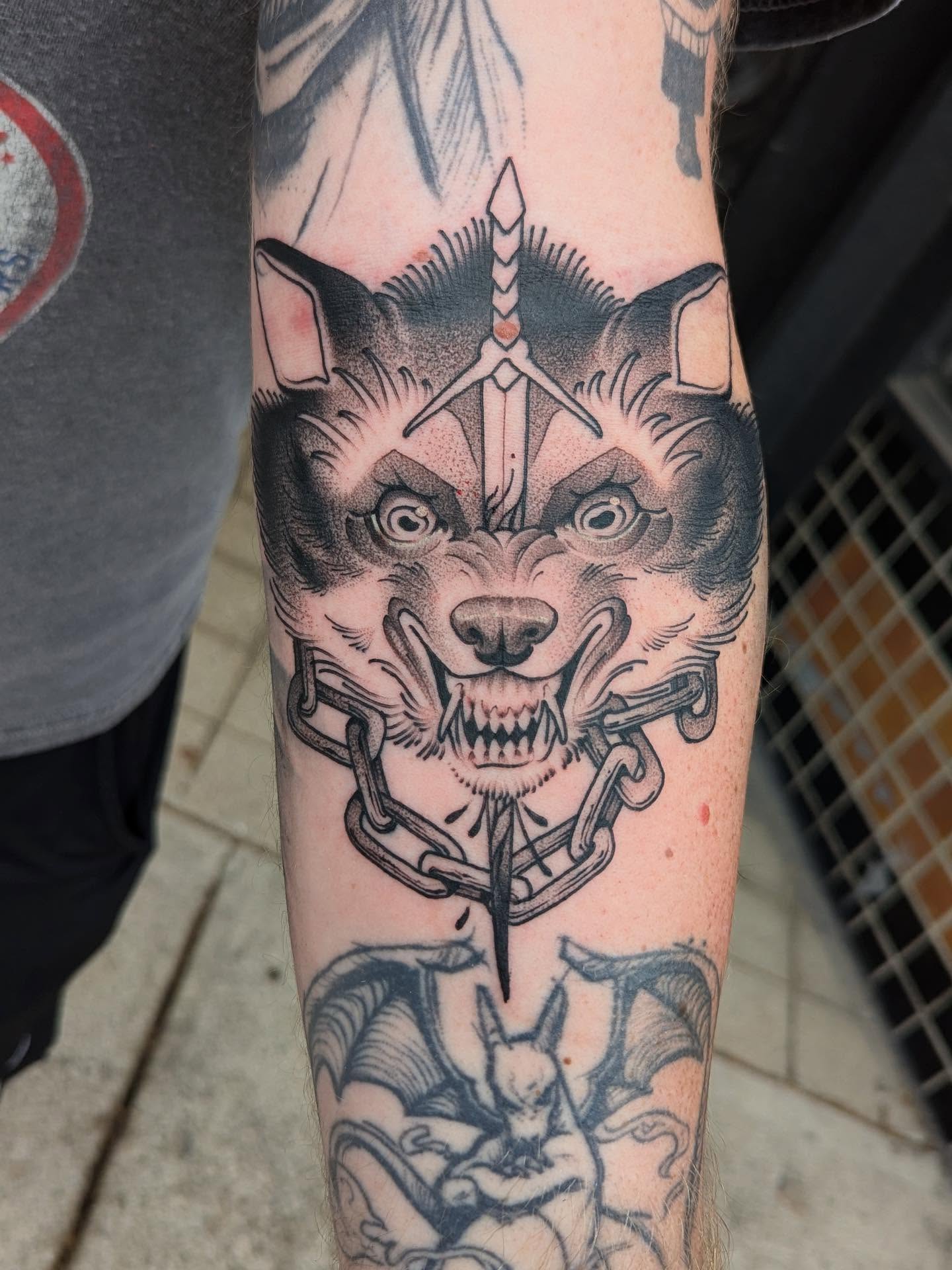 Wolf head with chains American traditional tattoo on the forearm by Kyle Kozek, Columbus, Ohio