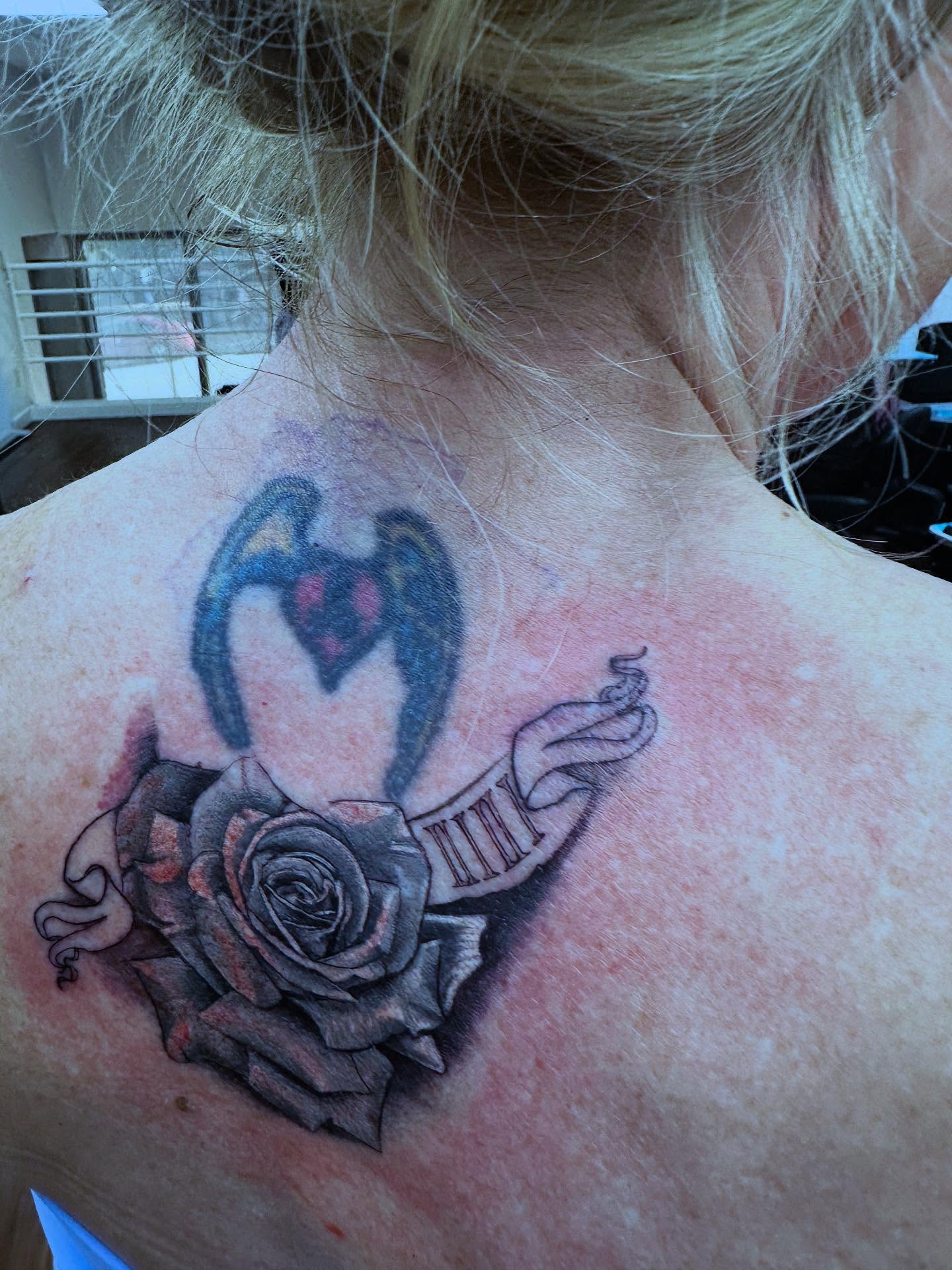 Heart with wings and rose realism tattoo on the back by Aaron Hassler, Nashville, Tennessee