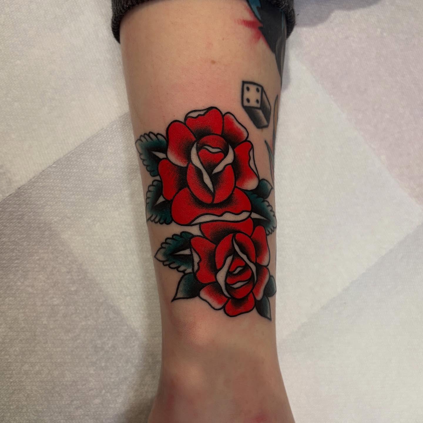Red roses American traditional tattoo on the forearm by Texas Jonah