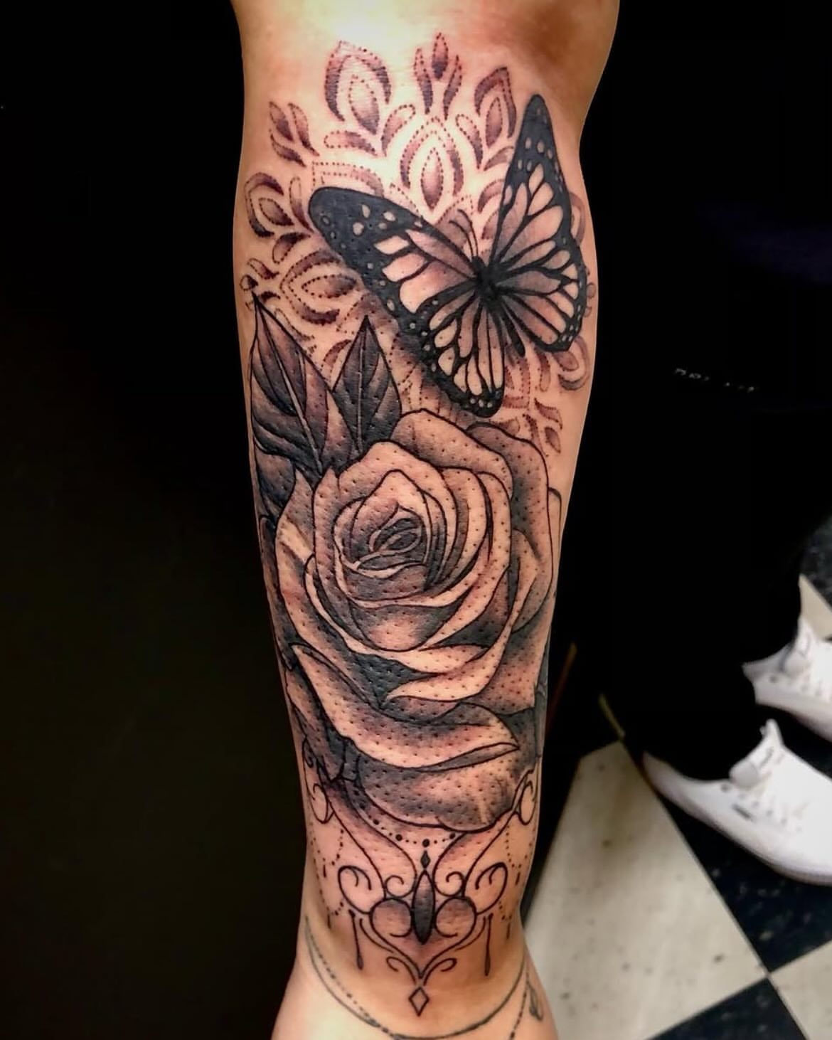 Rose and butterfly dotwork tattoo on the forearm by Jon Byrd