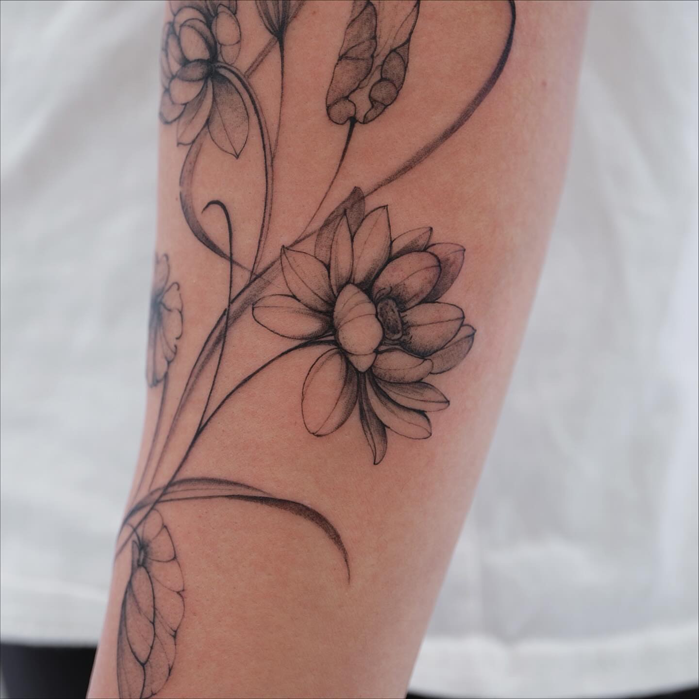 Floral design black and grey tattoo on the forearm by MJ tattooist